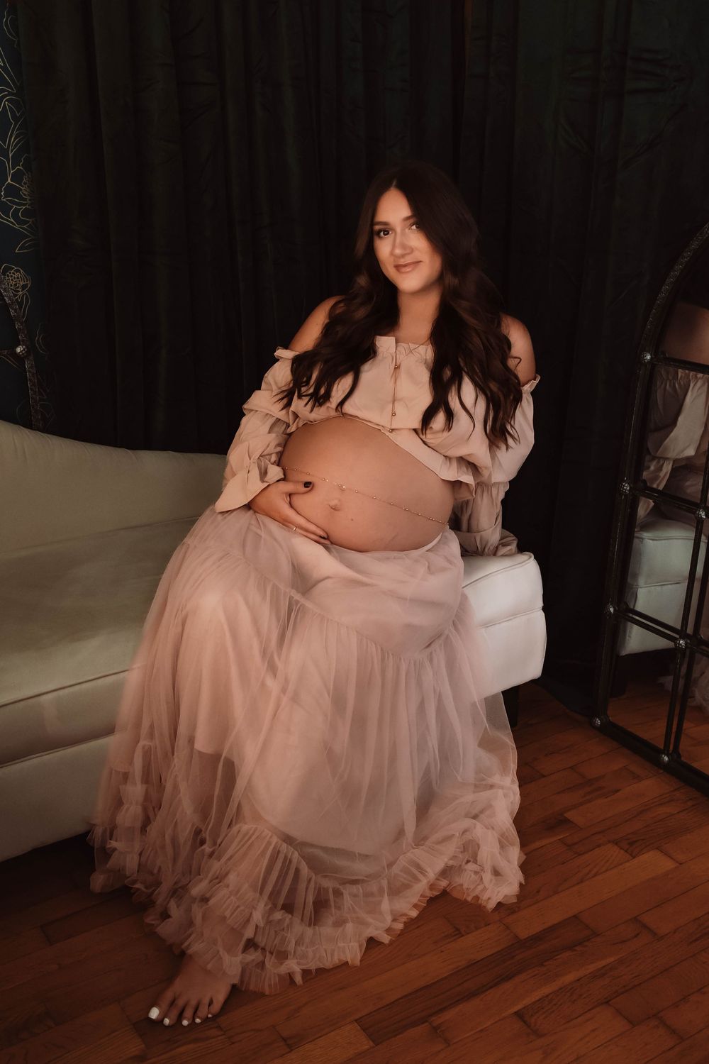 low light maternity session photographed in an intimate studio space