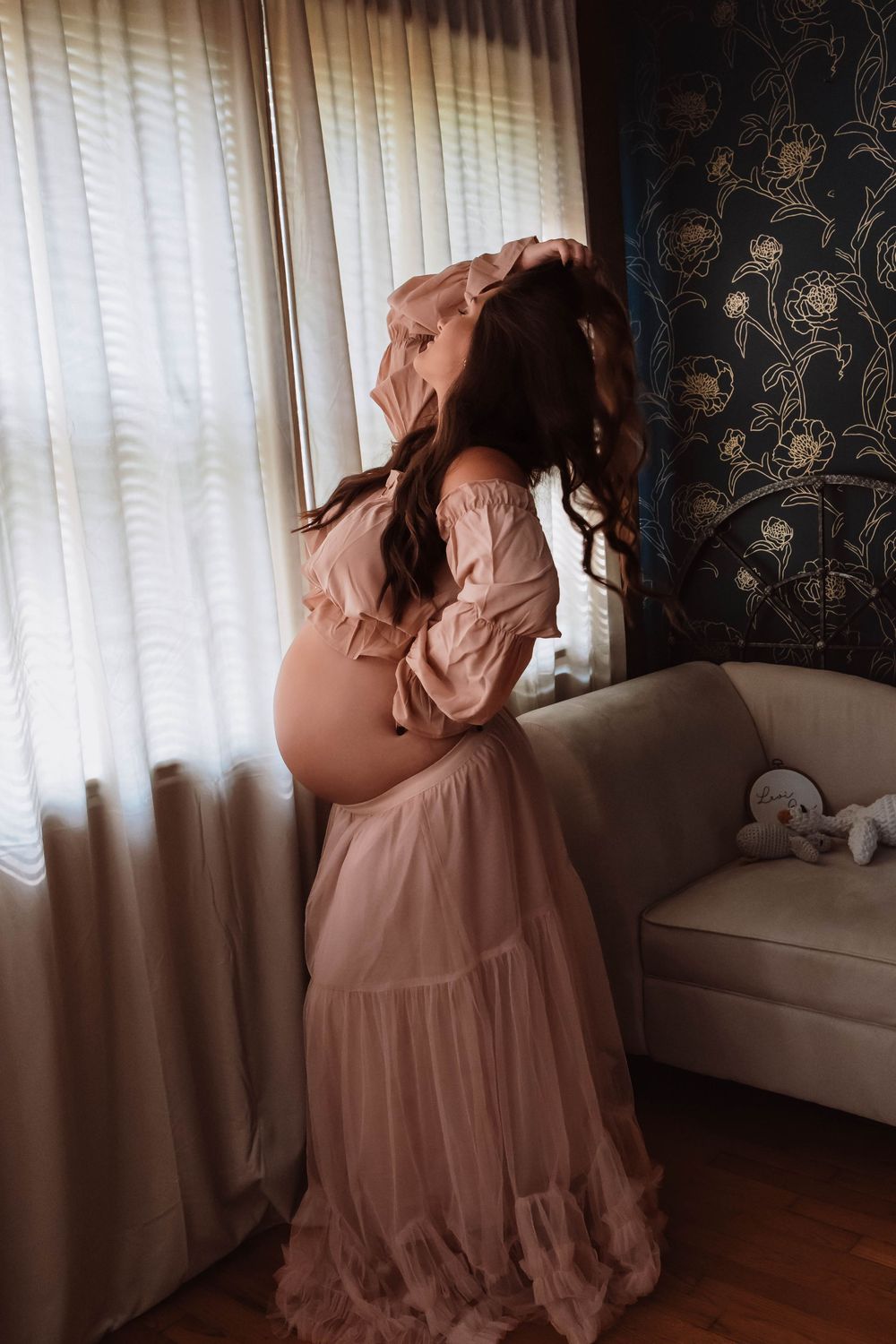Expectant mother captured in an intimate maternity session in a private studio