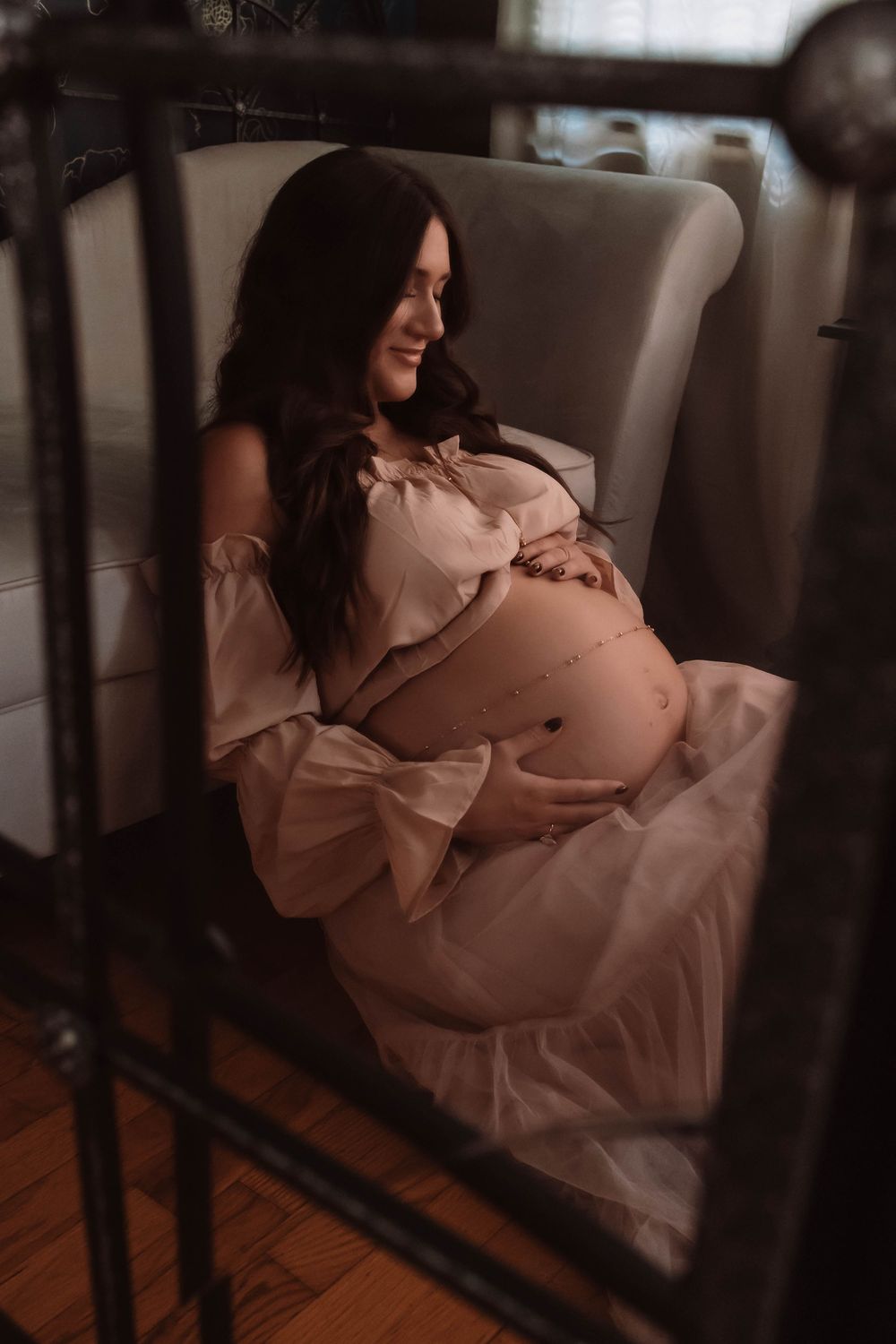 Moody maternity photography captured in a private studio with soft natural light