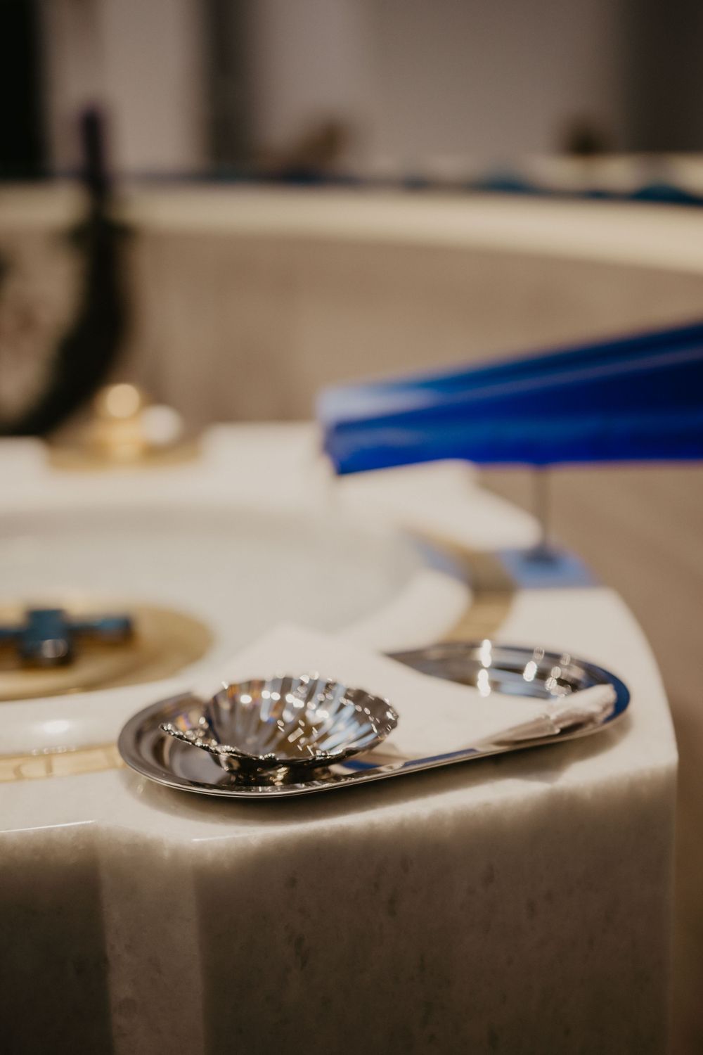 Silver ceremonial items and vessels arranged on a white tablecloth.