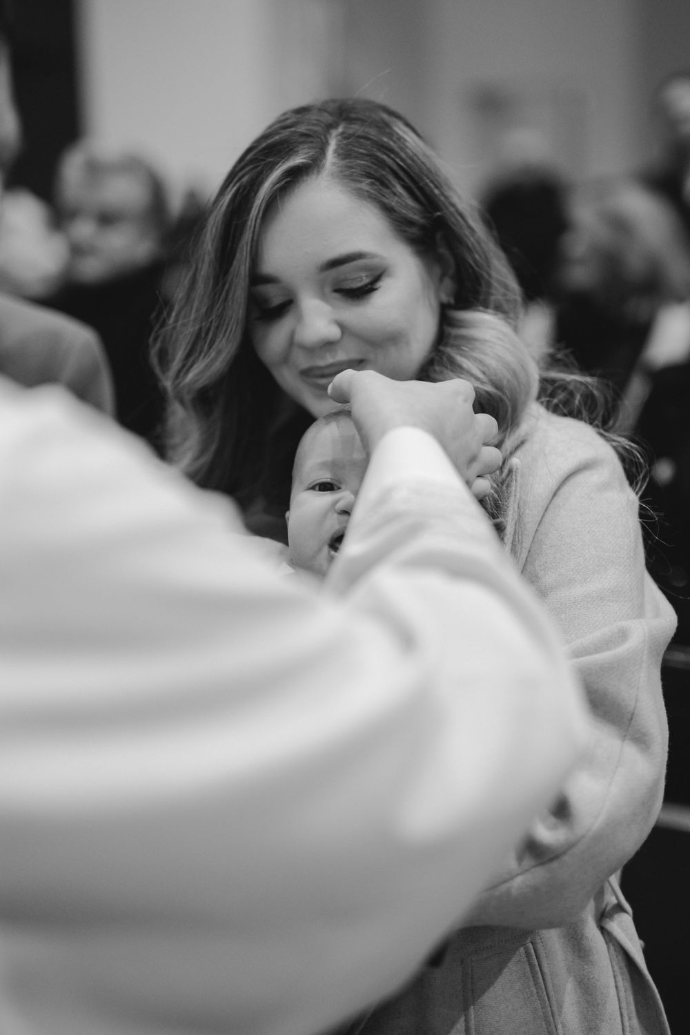An intimate moment during a religious ceremony as participants gather closely.