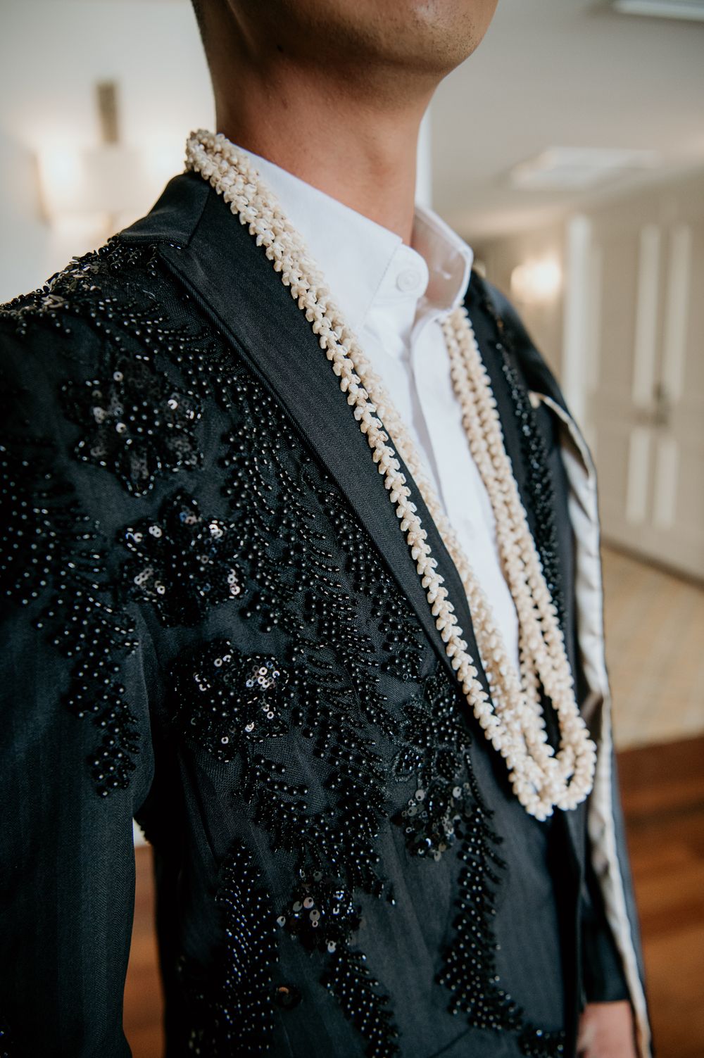 Close-up of an embellished black jacket with intricate beadwork details.