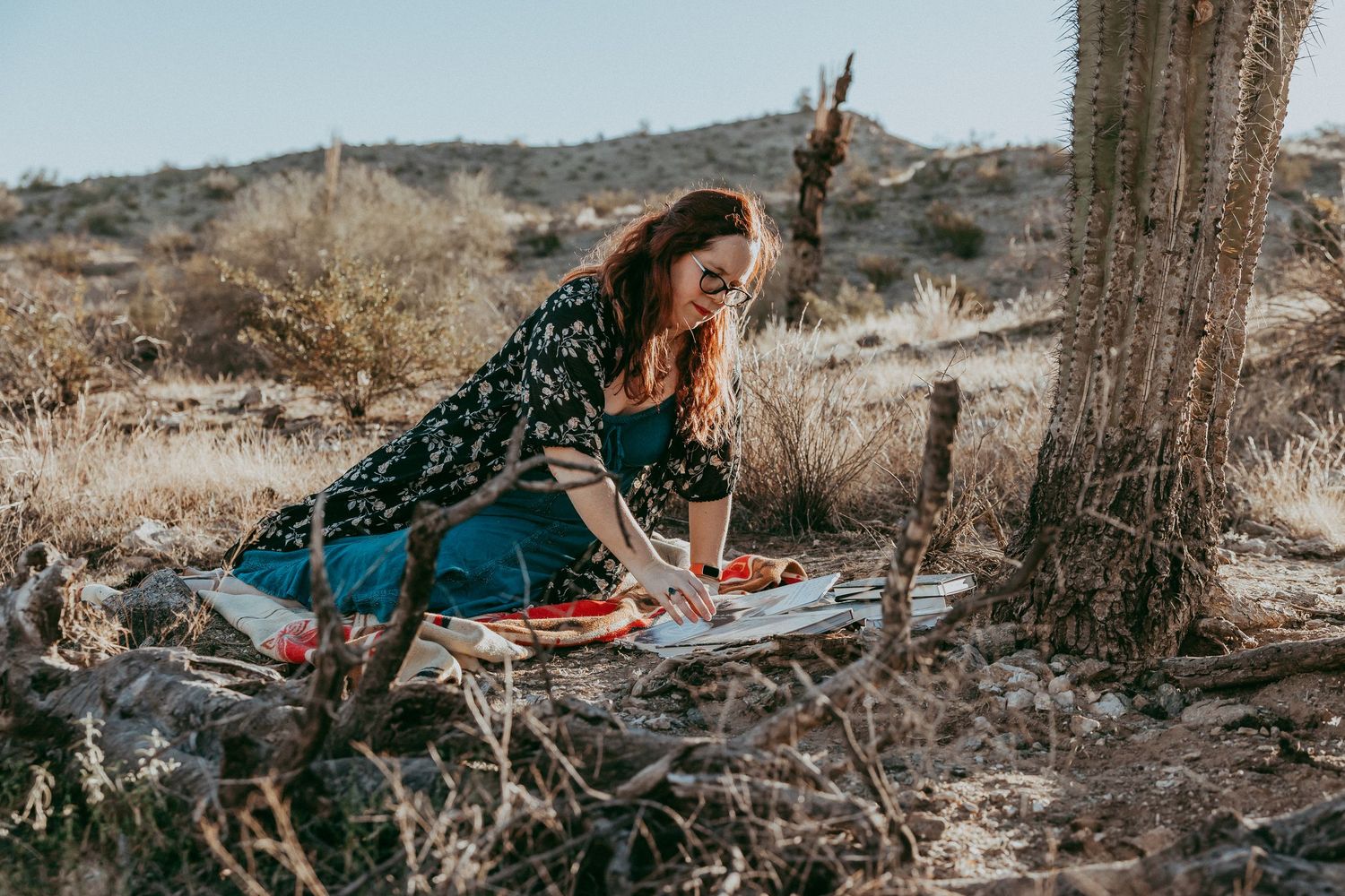 A woman rests in the desert near a cactus and journals. Whitney Popp, Phoenix Arizona photographer.