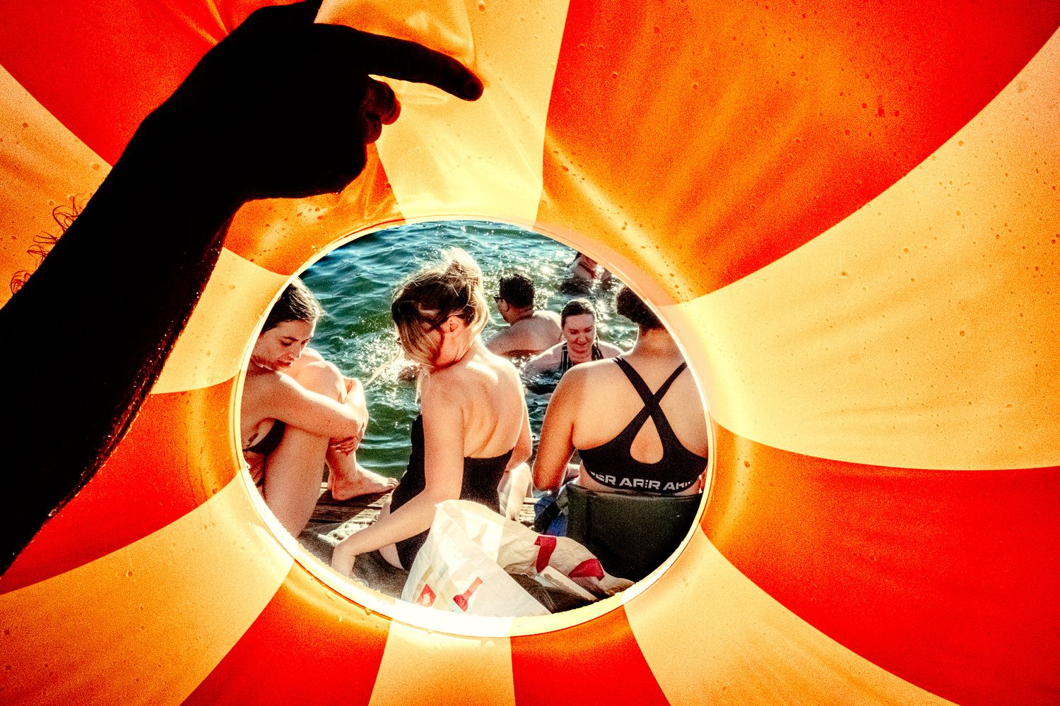 Artistic circular photo framed by red and orange sunburst pattern.