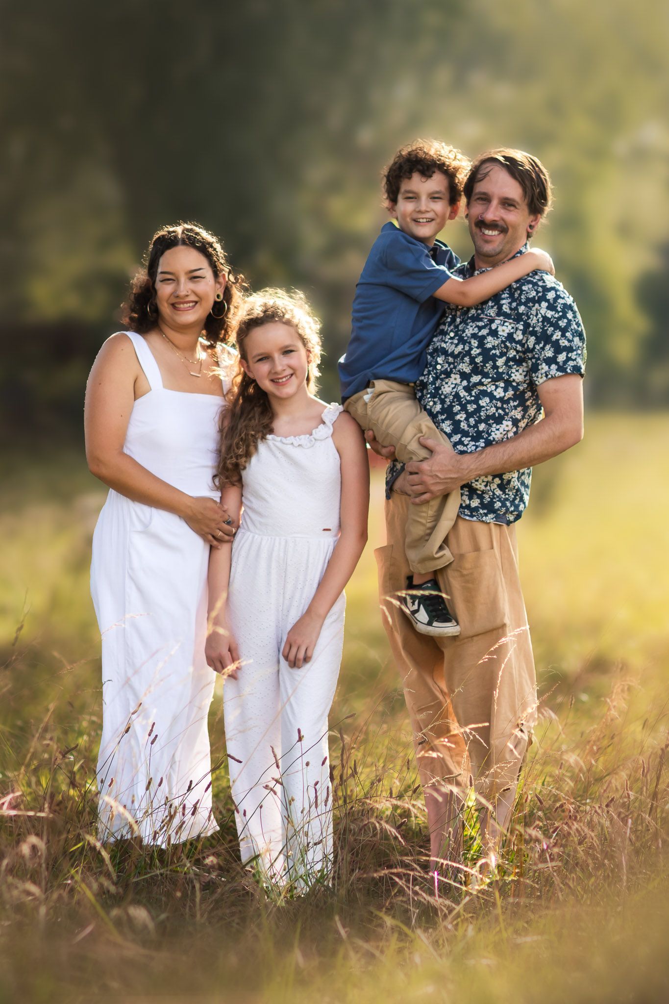 Smiling family in a Galena field during a family photoshoot, Captured by Joplin family photographer.