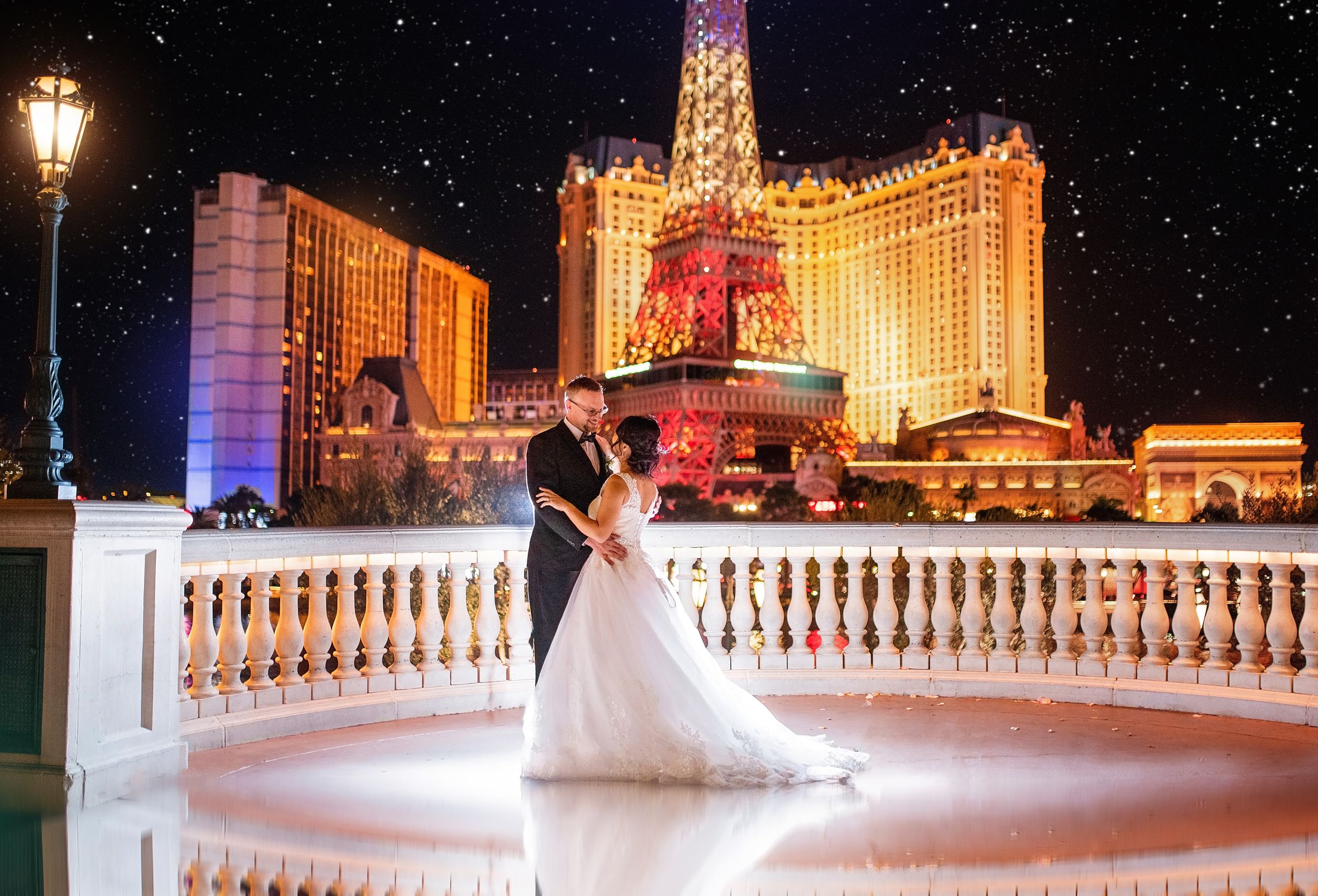 A romantic nighttime scene at the Bellagio Hotel in Las Vegas with its iconic fountains and glowing lights in the background.