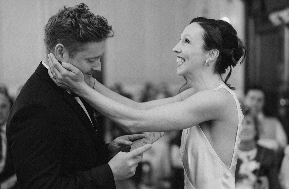 Black and white candid photo of an emotional moment during a wedding dance.