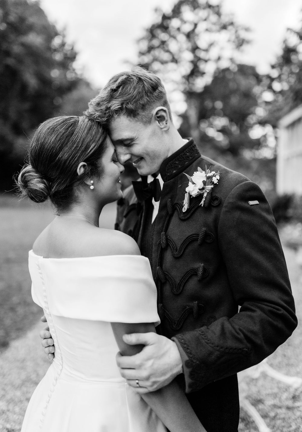 A romantic black and white wedding sequence showing a couple embracing and dancing outdoors.