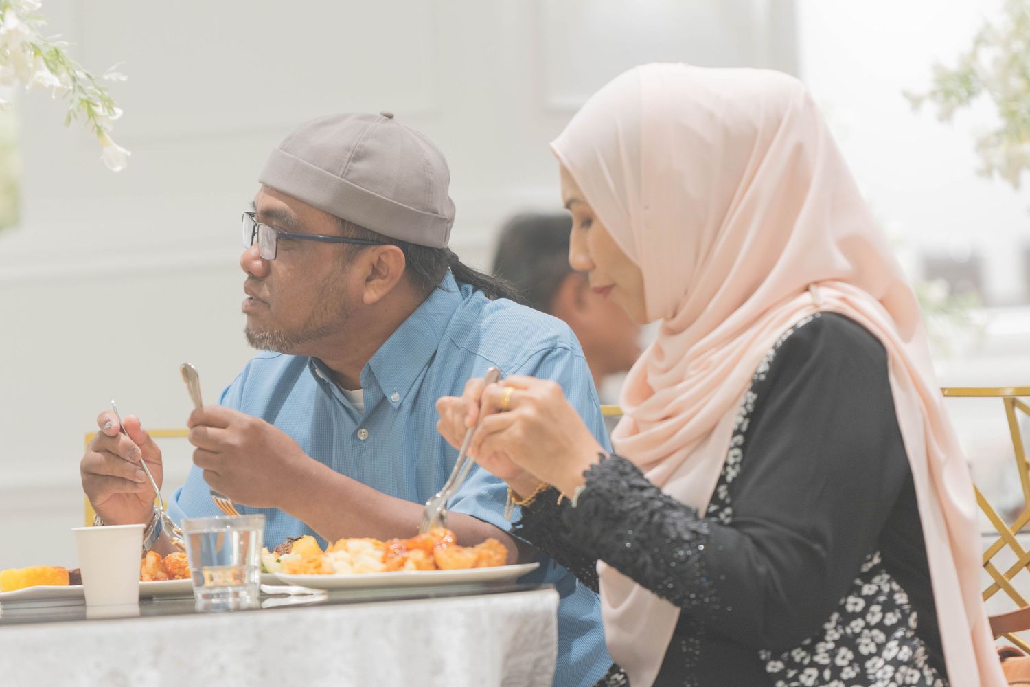 Couple enjoying meal together at casual dining setting.