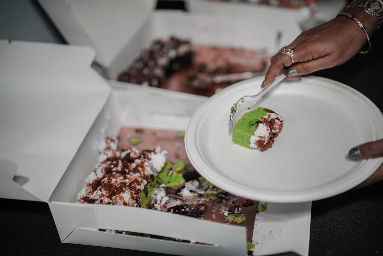 Someone plating an elegantly garnished dessert at an upscale event.