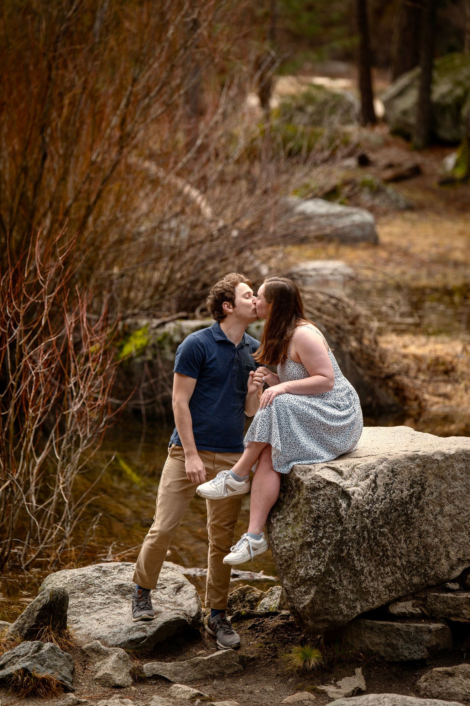 A couple giving romance at Mirror Lake, Yosemite, after a surprise proposal and fun hike together