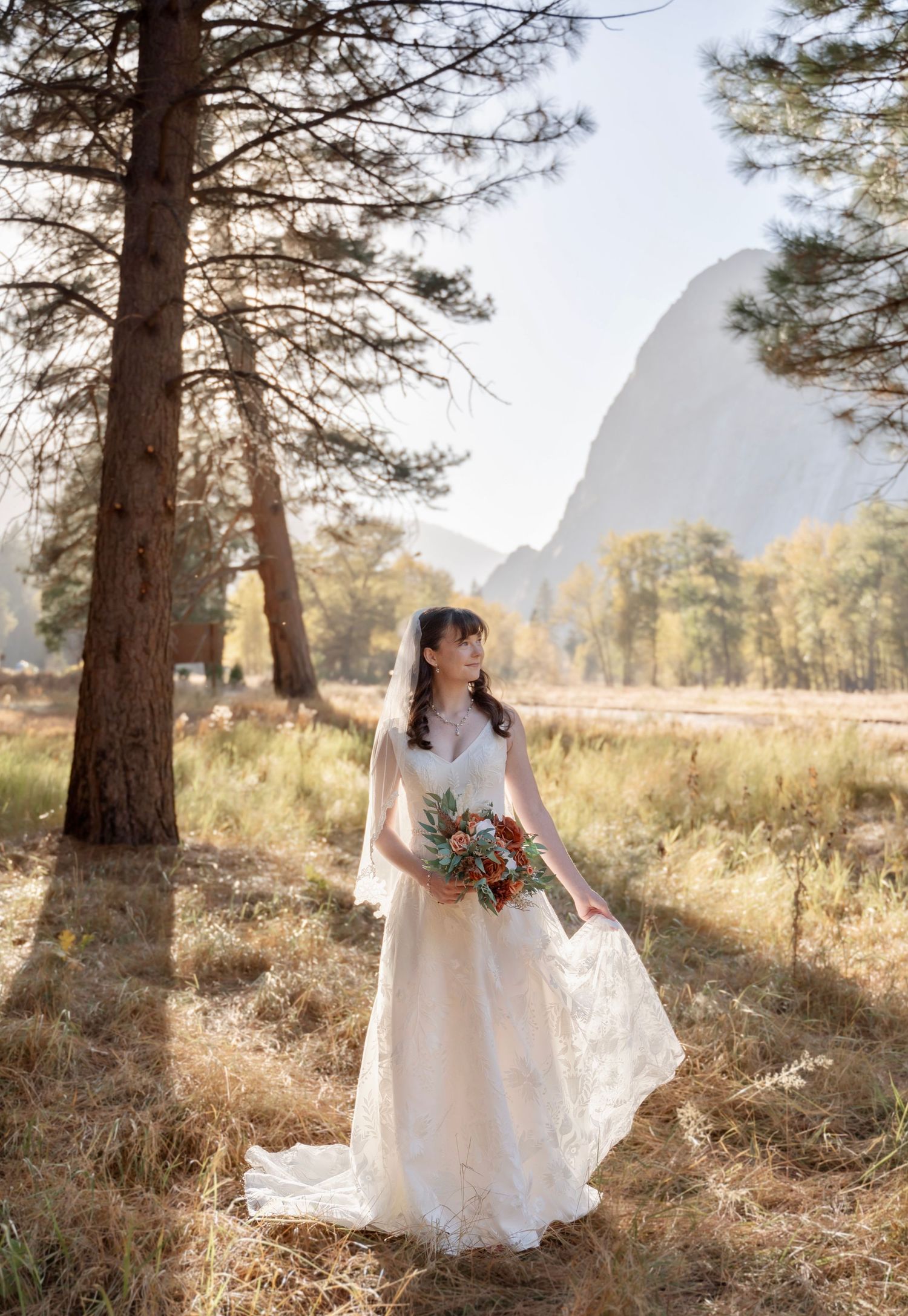 A bridal portrait in a backlit meadow by Yosemite Chapel