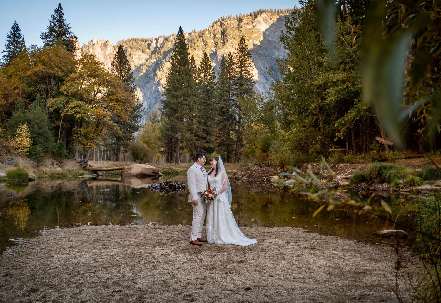 A bride and groom eloping on a sandy beach in Yosemite, California