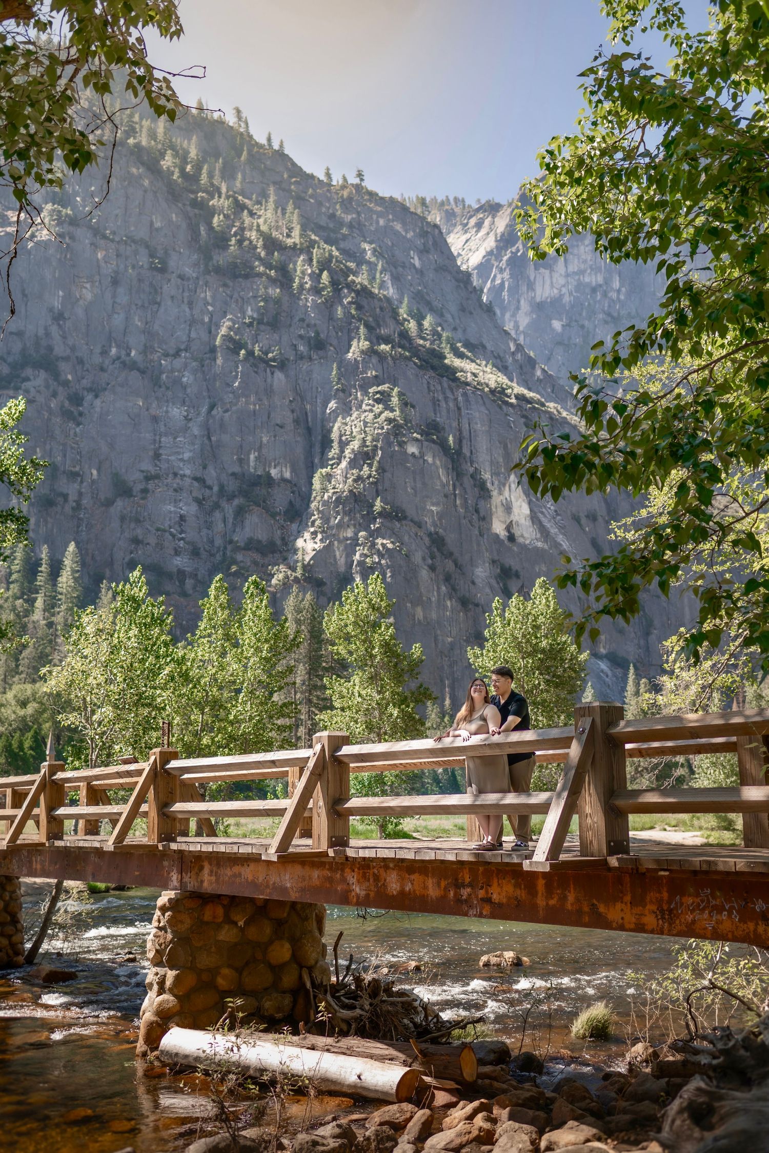A bride and groom hug on Sentinel Bridge, Cook's Meadow, Yosemite, California