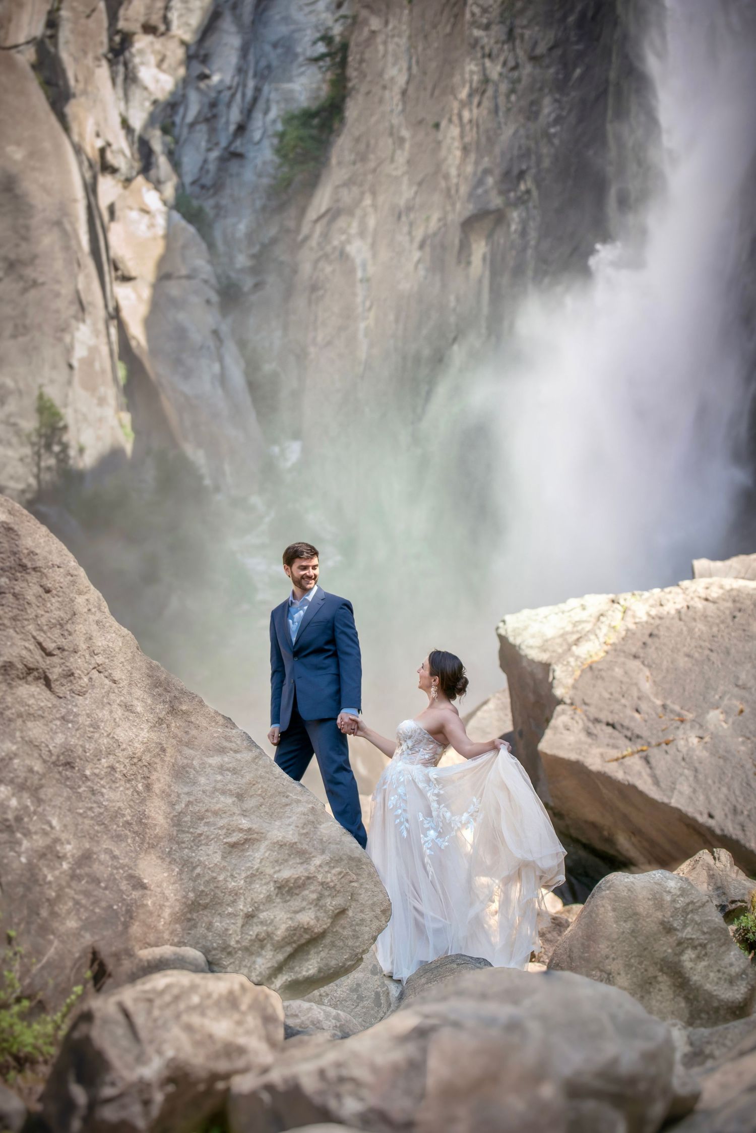 A bride and groom explore Yosemite falls