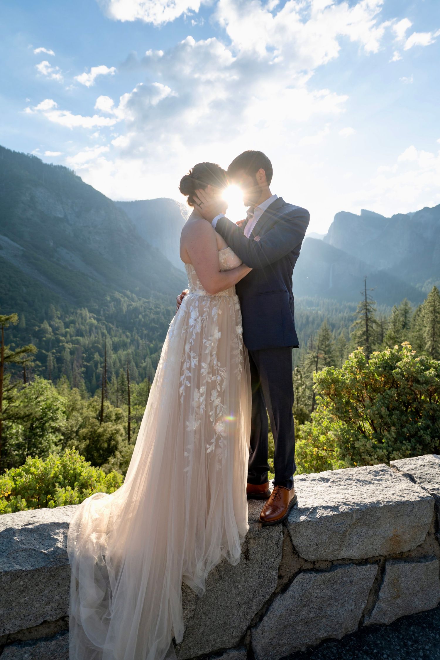 An elegant bride and groom embrace in a soft sunrise at Tunnelview, Yosemite, Cailfornia