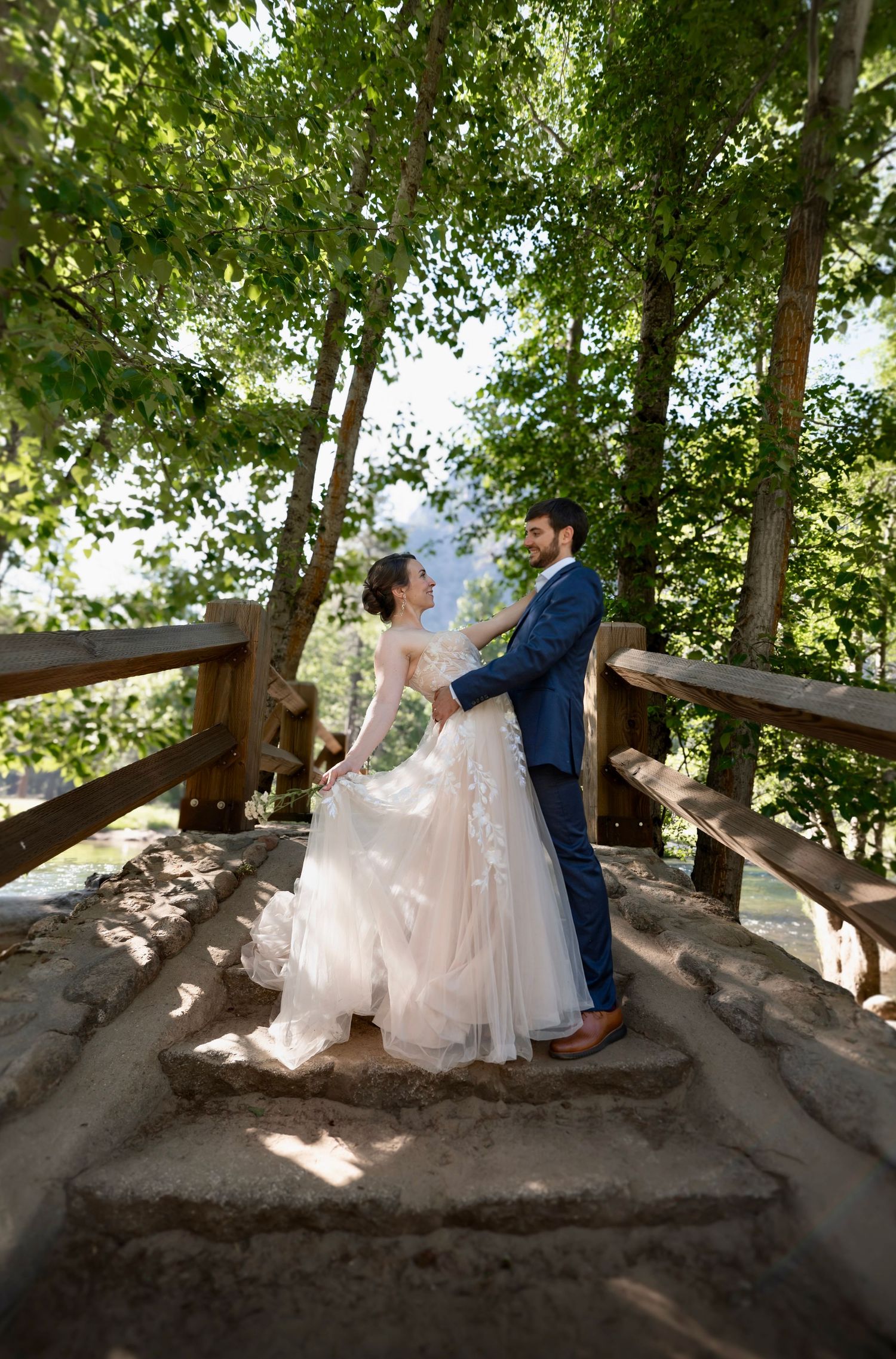A bride and groom elope and dance on Sentinel Bridge in Yosemite, California