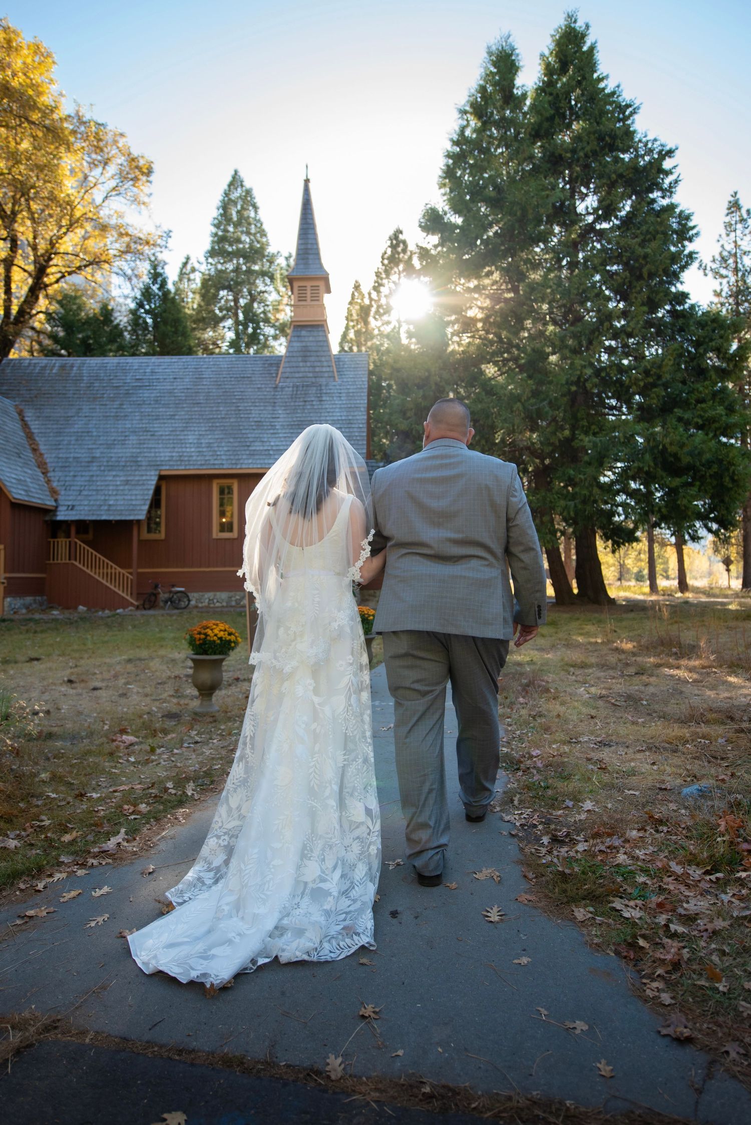 A bride being walked by her father down the aisle at Yosemite Chapel