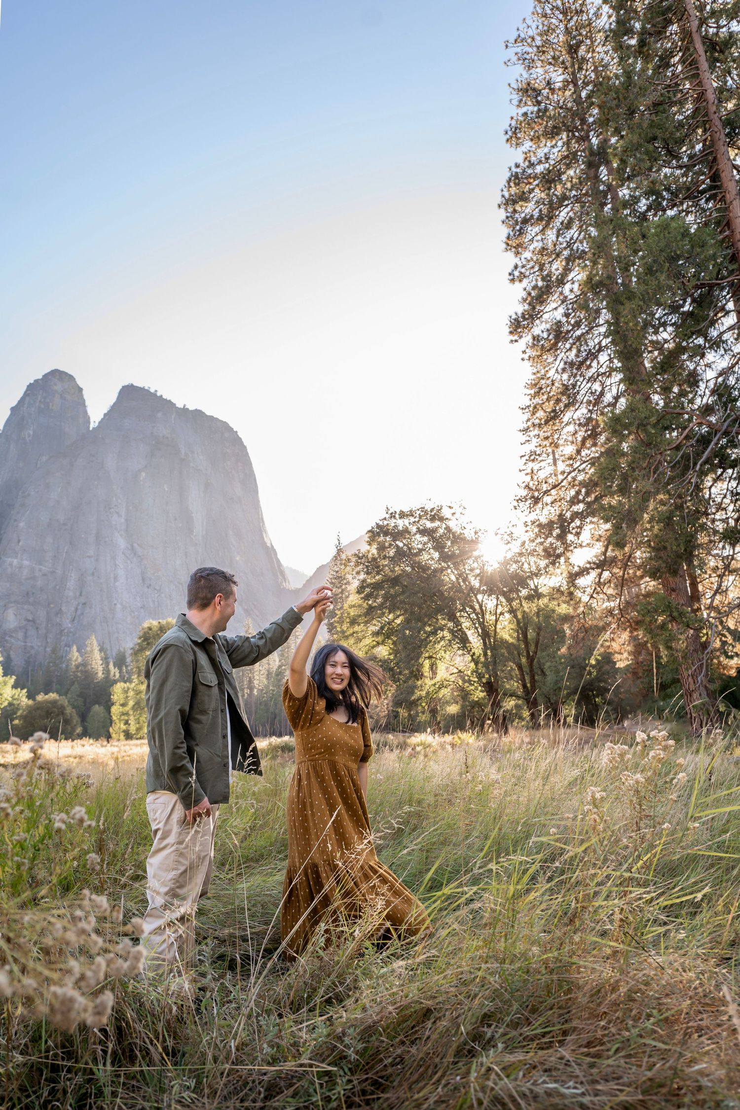 A couple dance and twirl in a meadow in Yosemite Valley