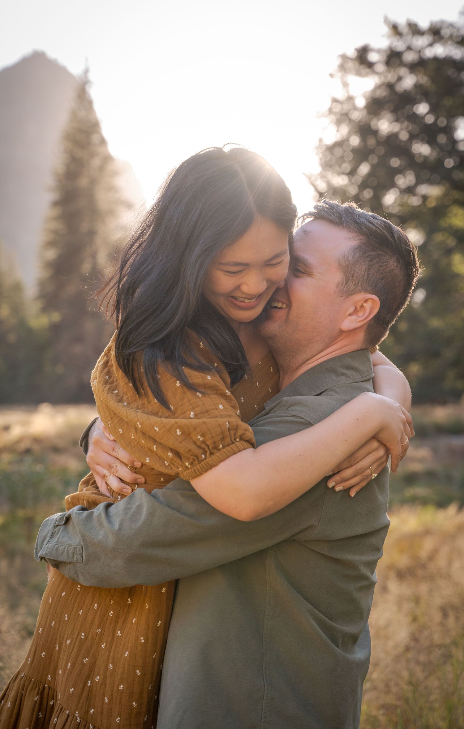 A couple hug in soft sunset light in Yosemite