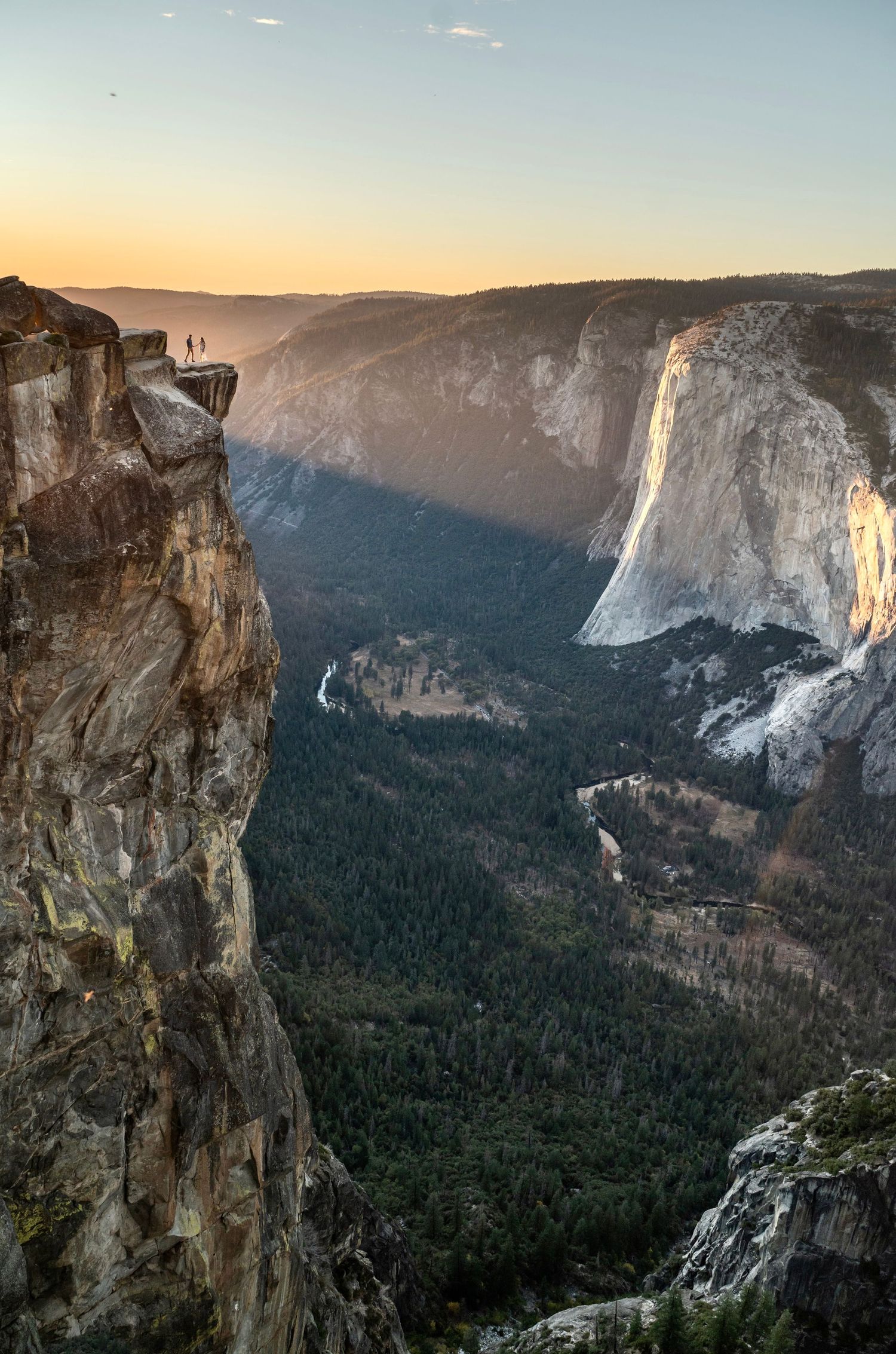 An epic Taft point Yosemite wide shot with a newly engaged couple in the sunset