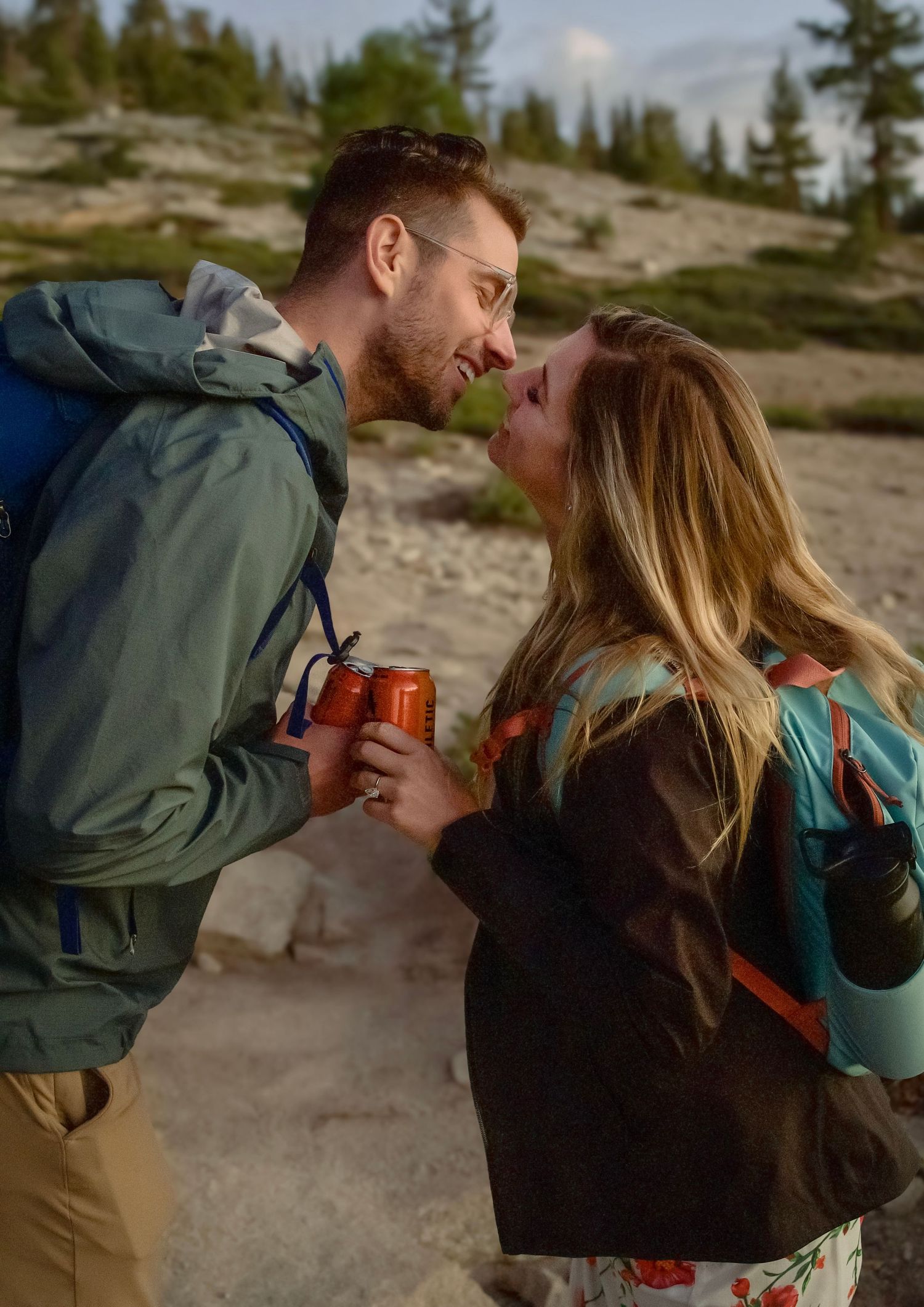 a kiss between a newly engaged hiker couple at yosemite cliffs