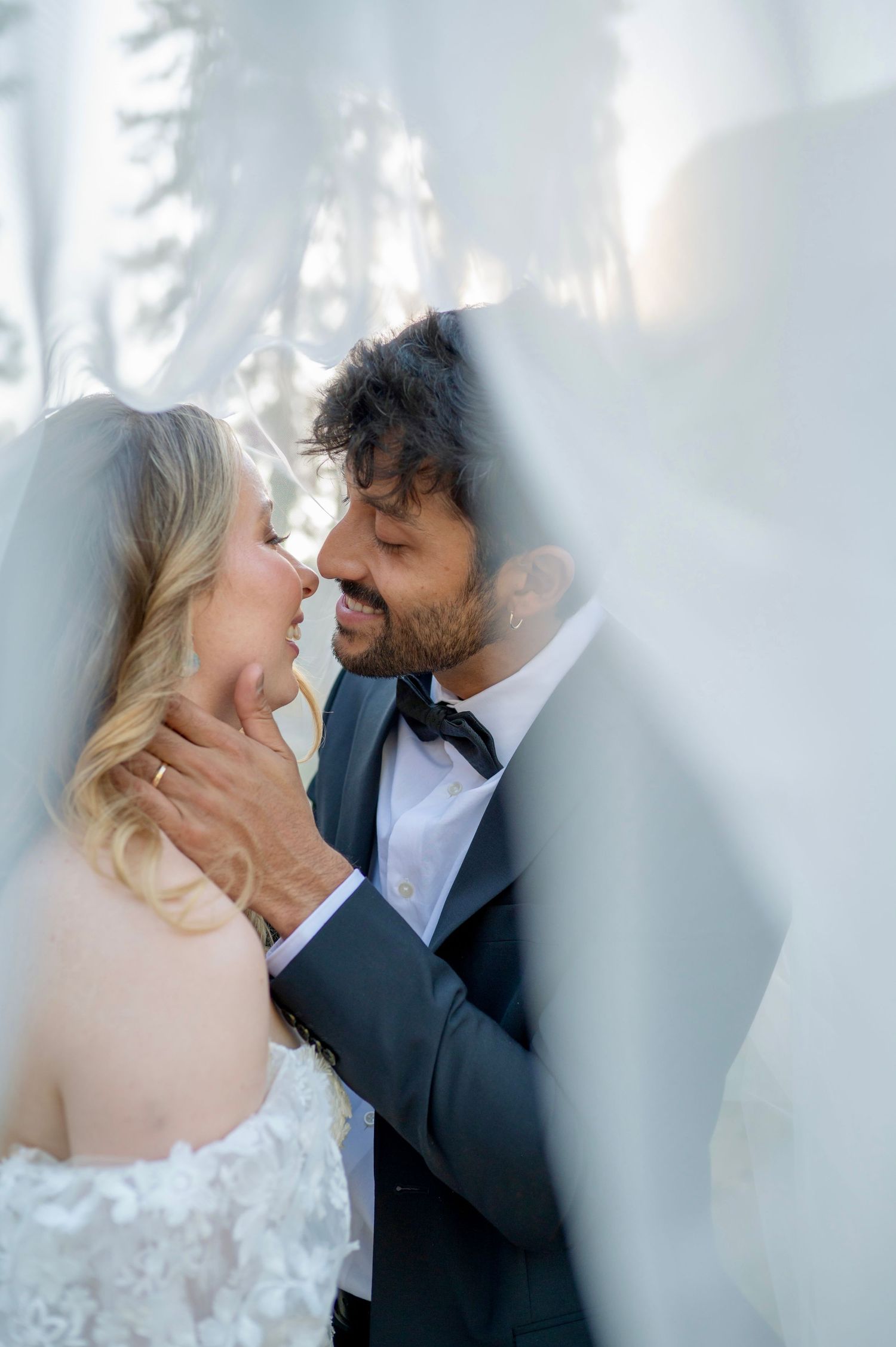 A beautiful bride and groom in the meadow at their wedding at Yosemite Chapel