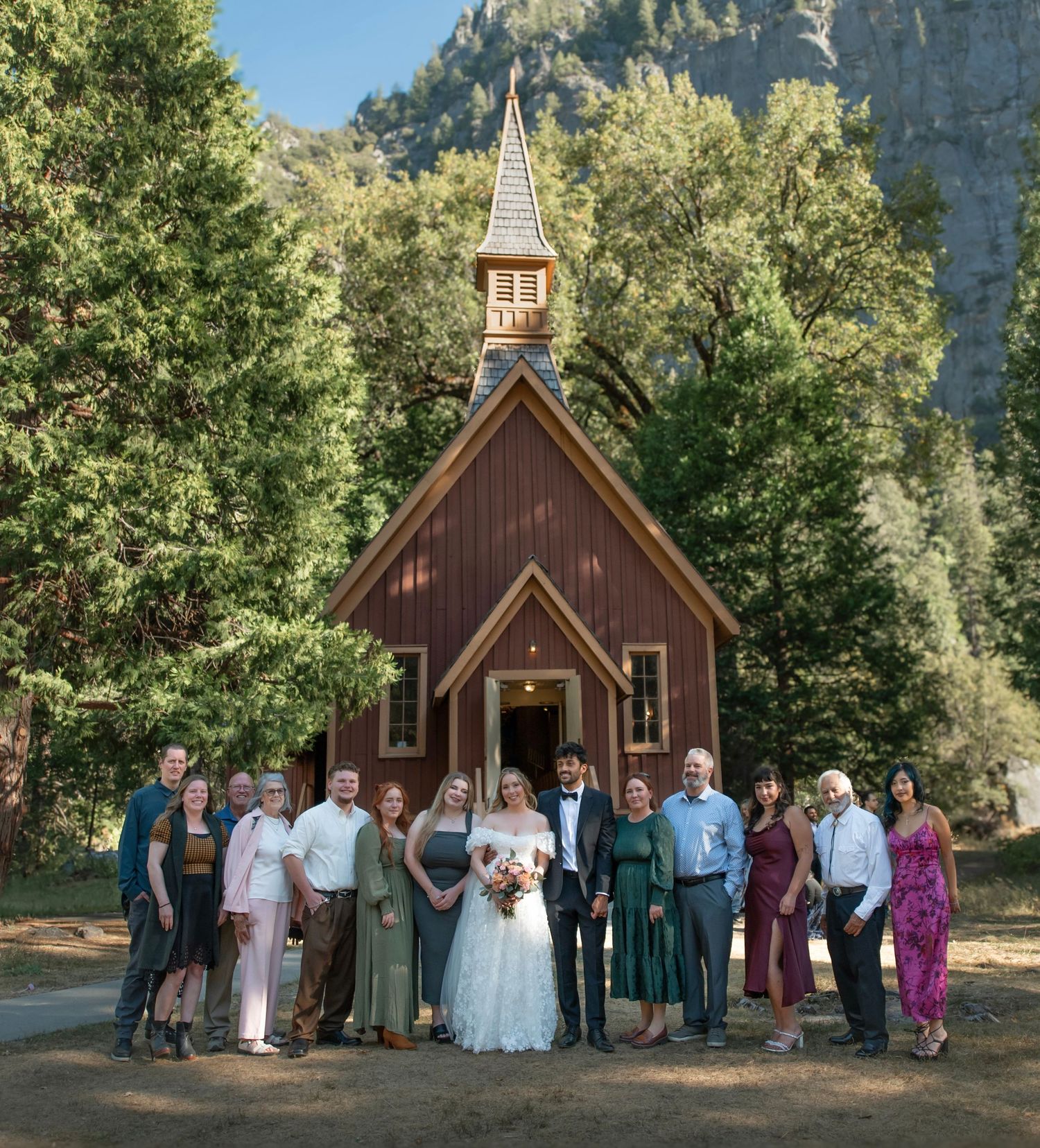 A beautiful bride and groom and their family at their wedding at Yosemite Chapel