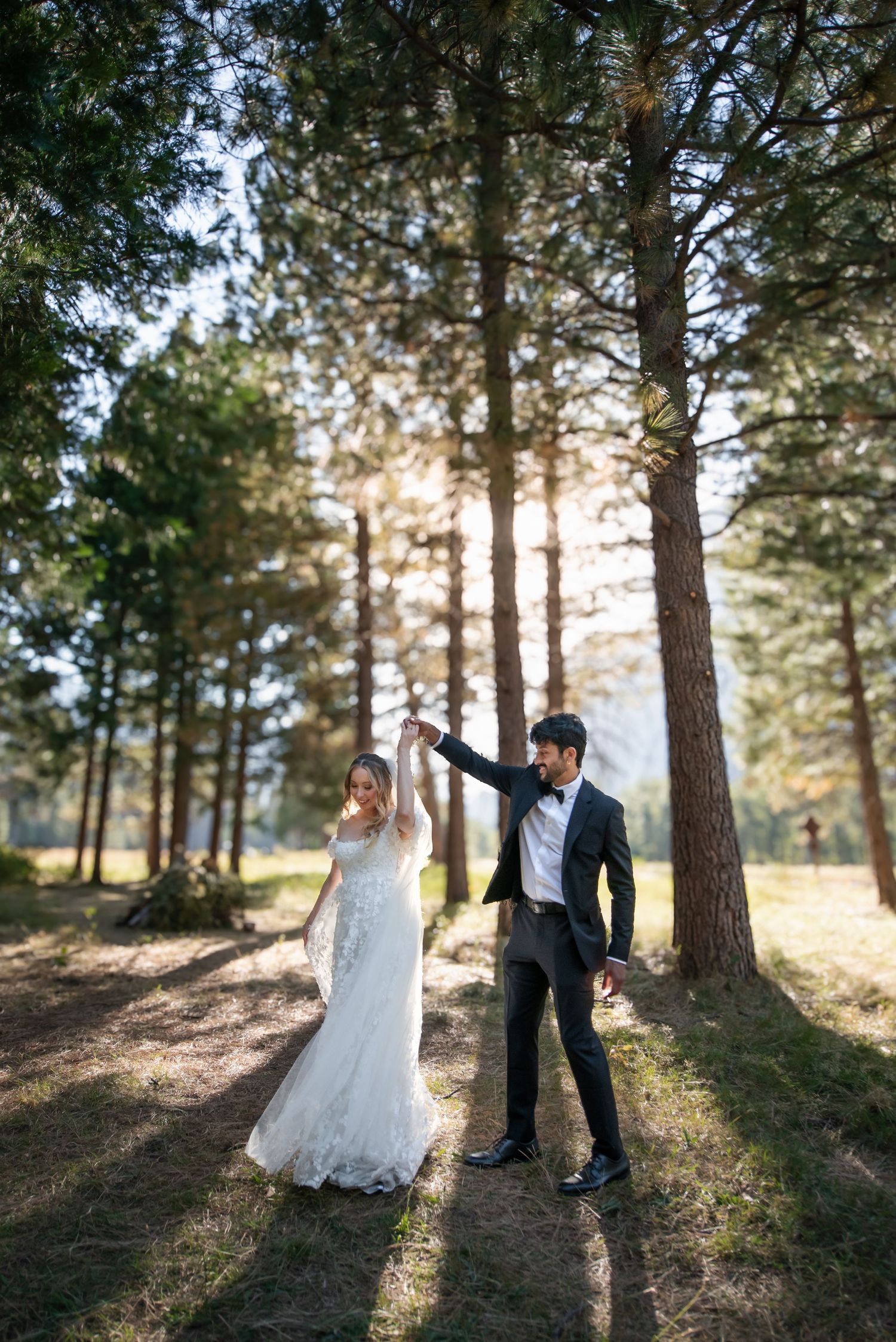A beautiful bride and groom in the meadow at their wedding at Yosemite Chapel