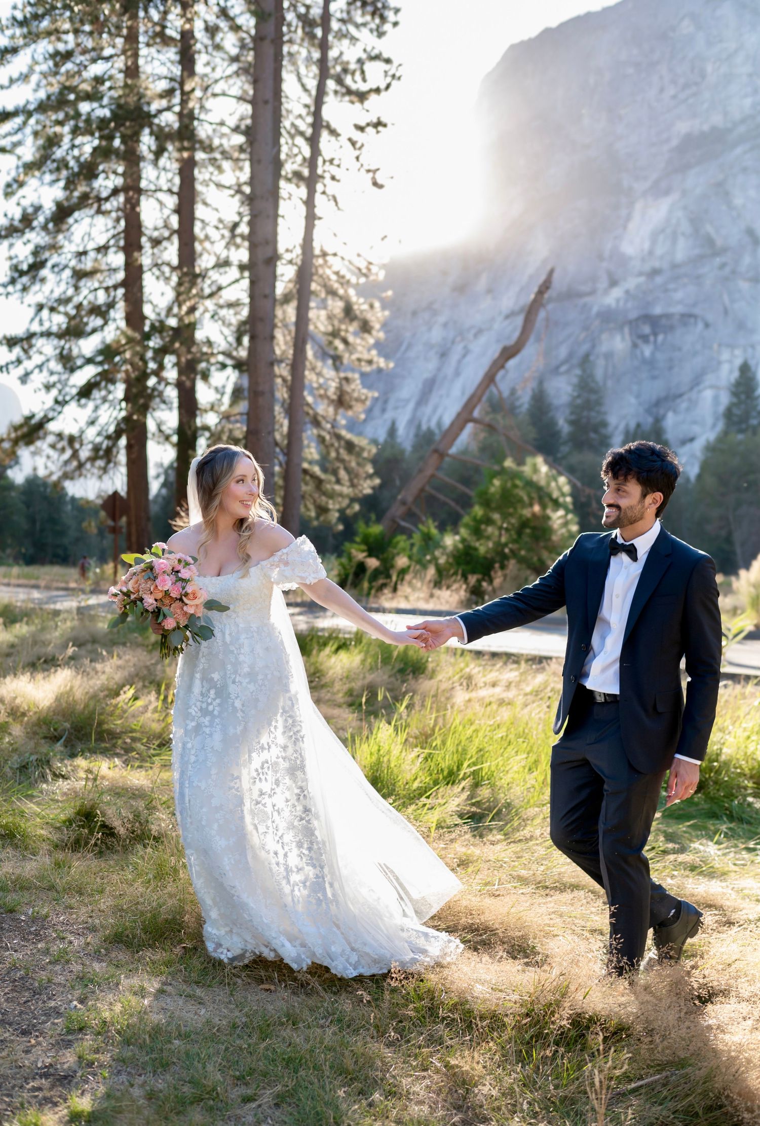 A beautiful bride and groom in the meadow at their wedding at Yosemite Chapel