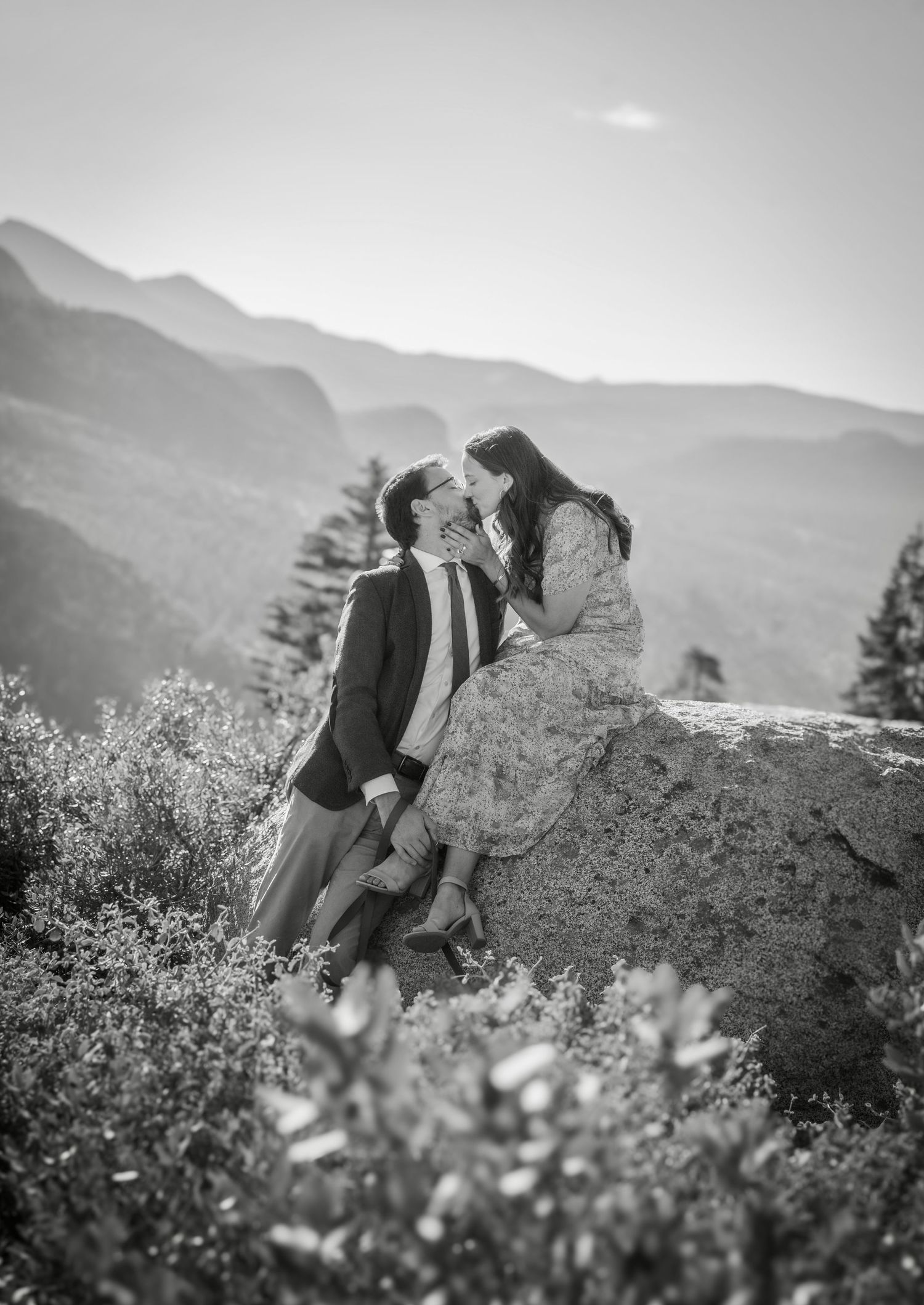 a beautiful engaged couple with their dog in Yosemite as a backdrop, at Glacier Point and Half Dome in the background