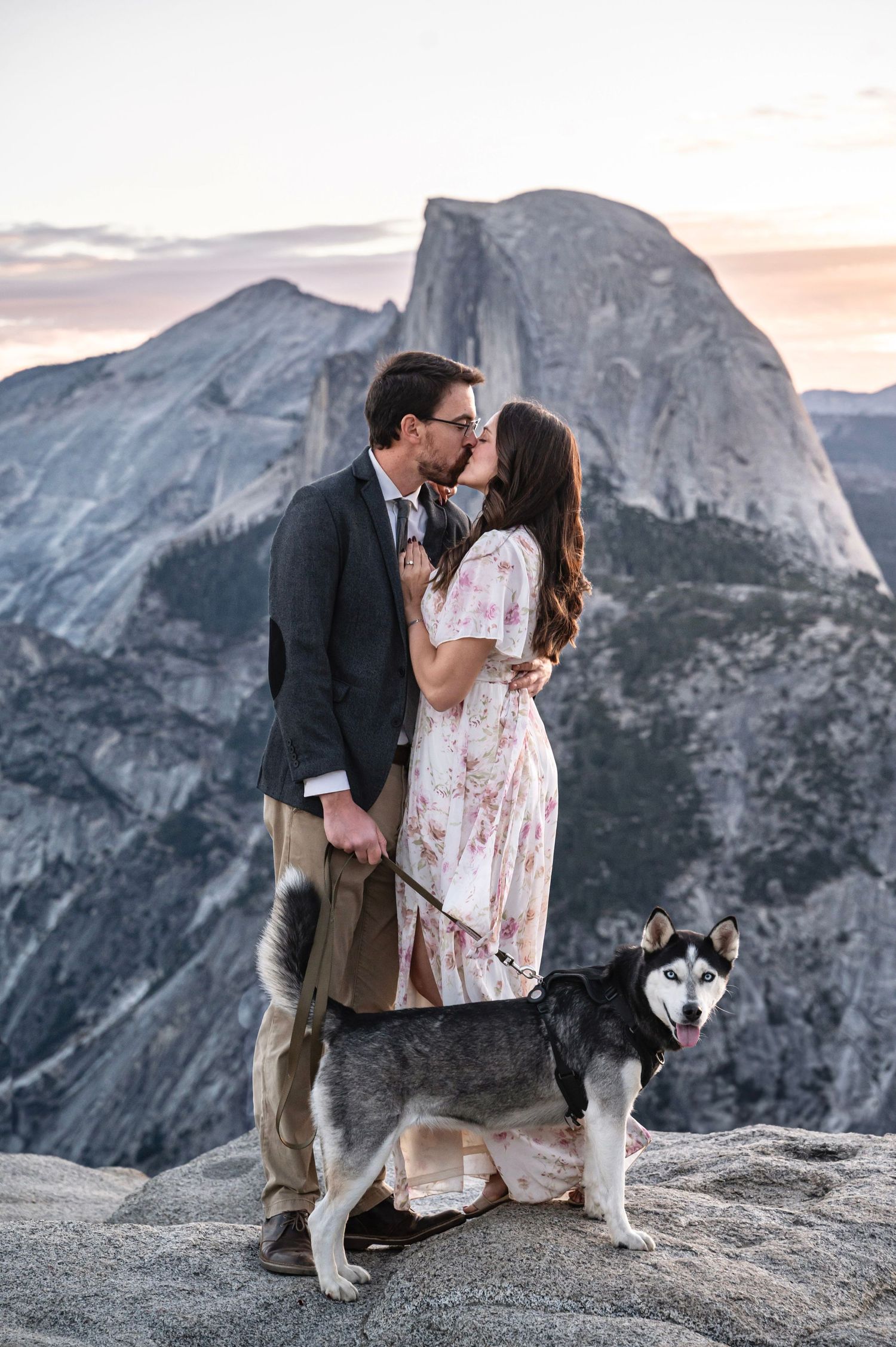 a beautiful engaged couple with their dog in Yosemite as a backdrop, at Glacier Point and Half Dome in the background