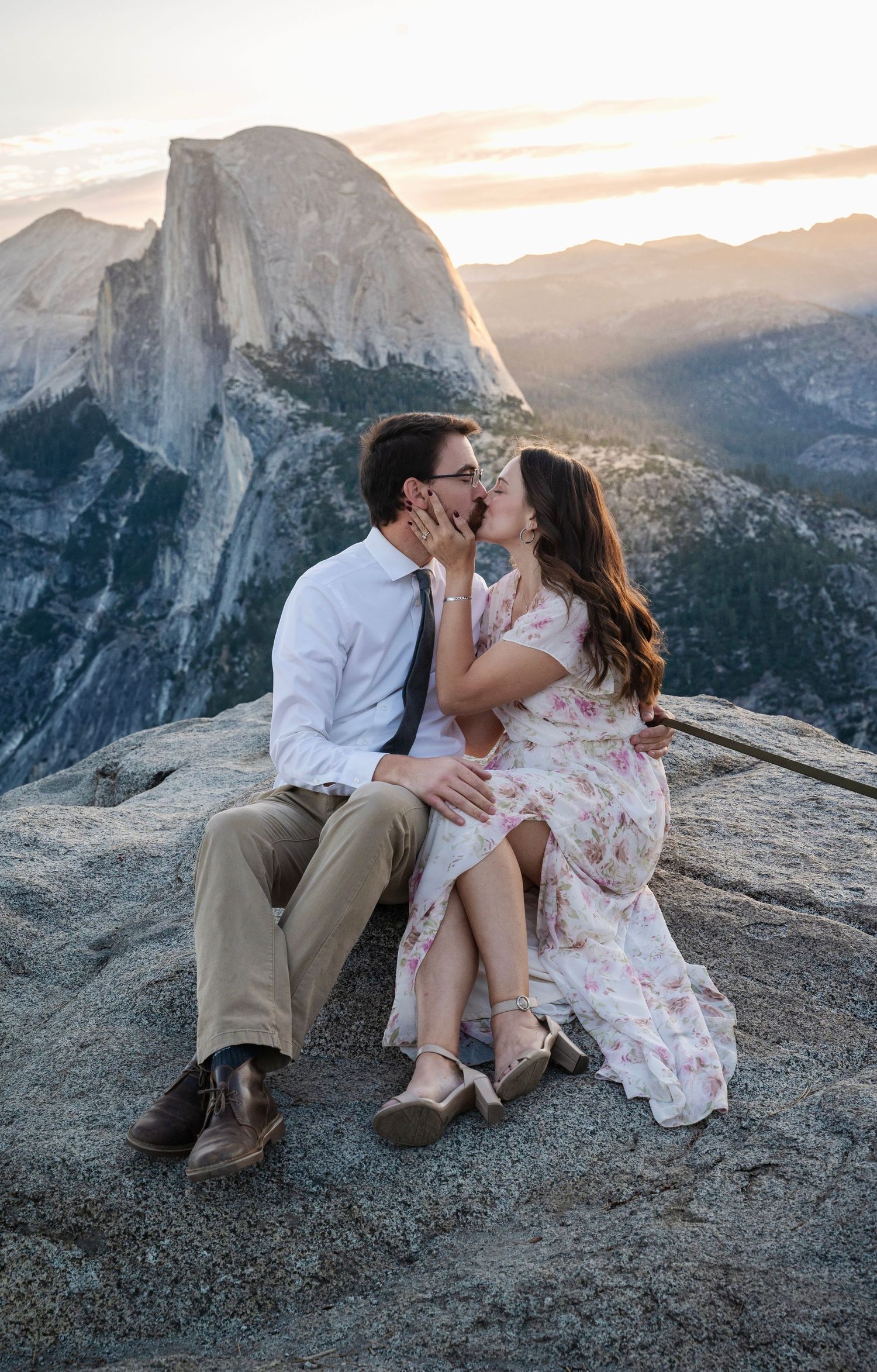 a beautiful engaged couple with their dog in Yosemite as a backdrop, at Glacier Point and Half Dome in the background