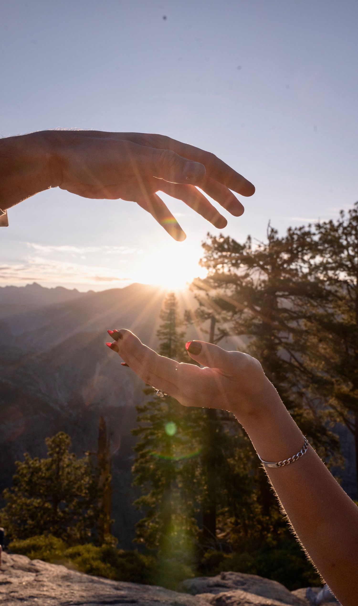a beautiful engaged couple with their dog in Yosemite as a backdrop, at Glacier Point