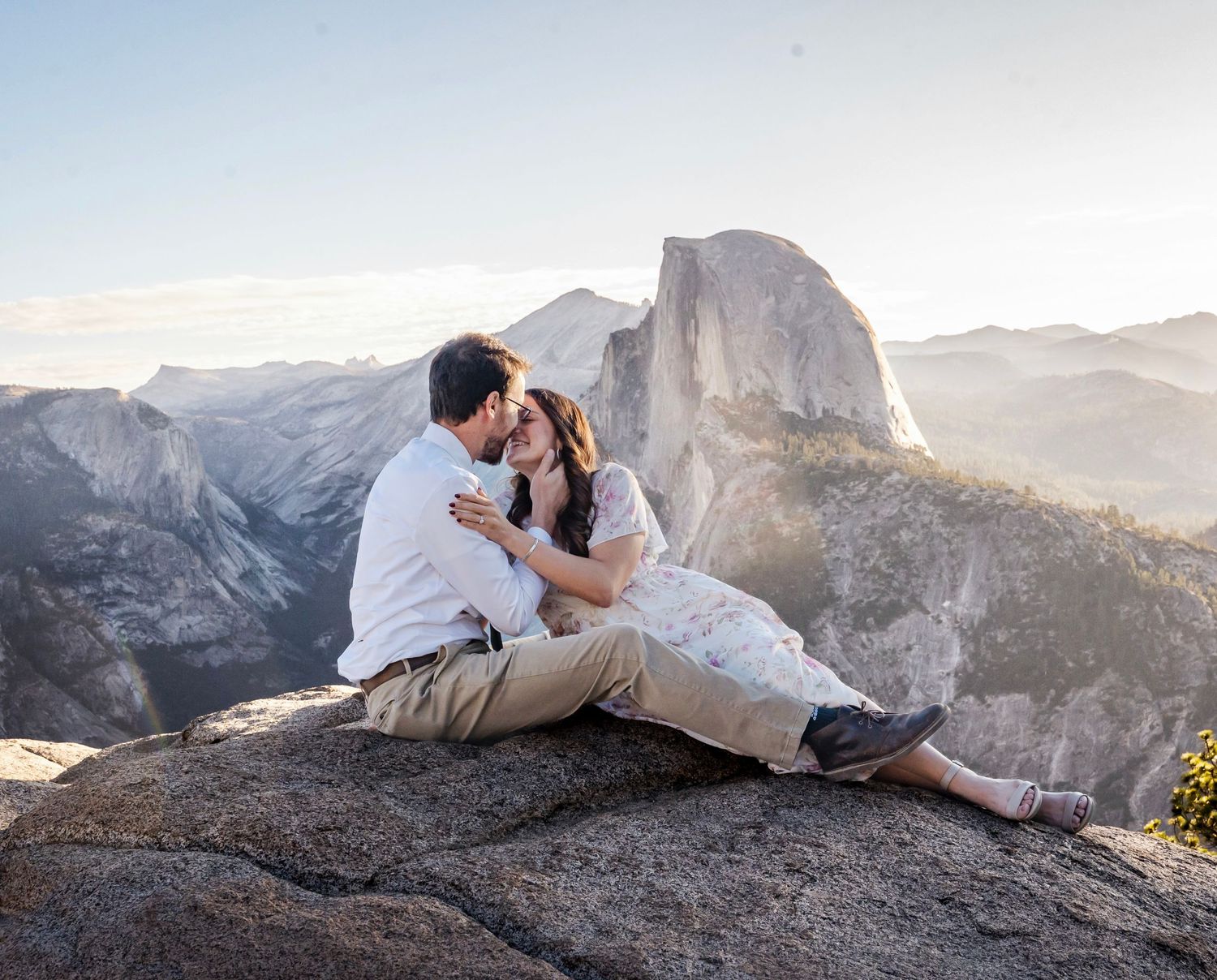 a beautiful engaged couple with their dog in Yosemite as a backdrop, at Glacier Point