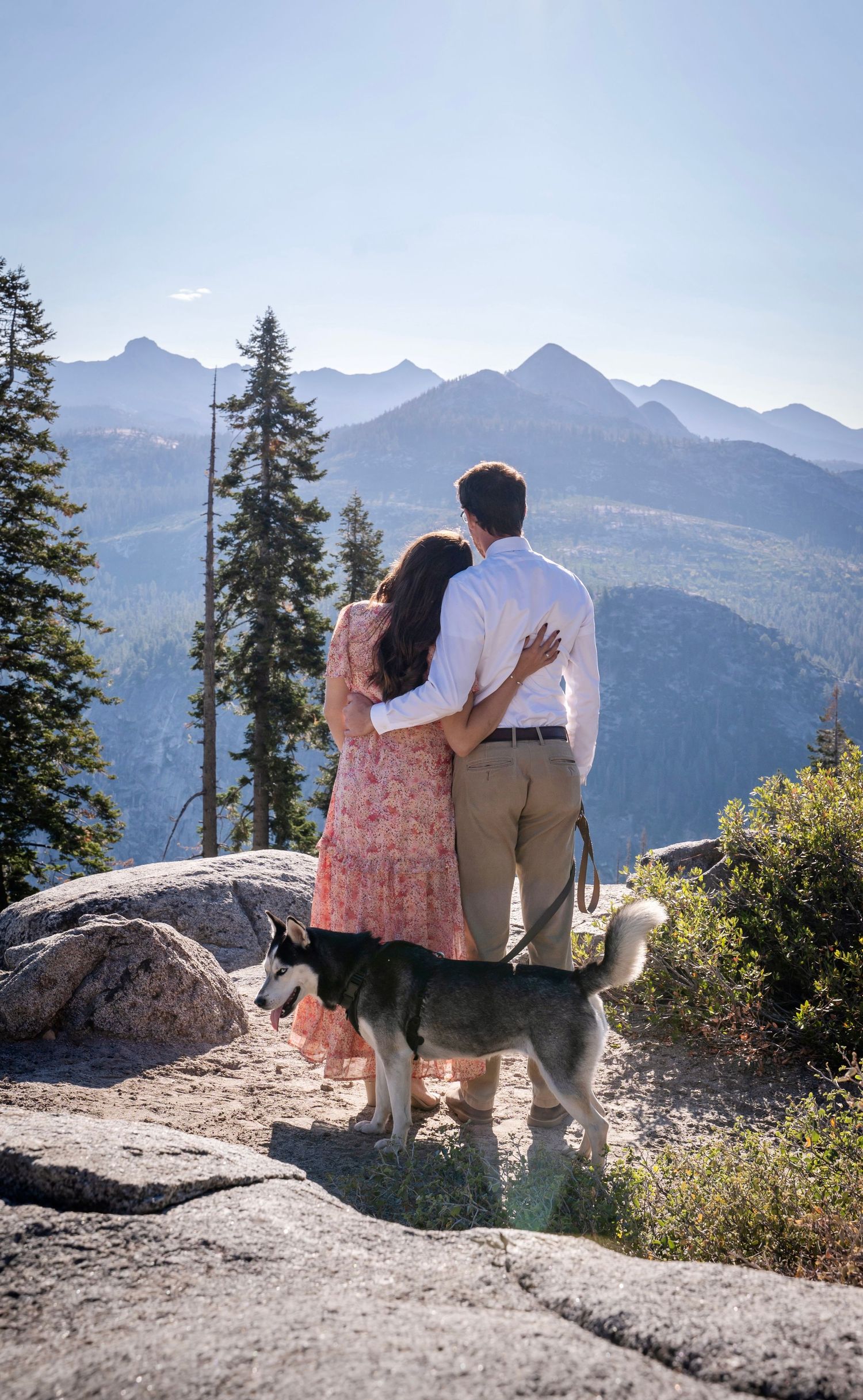 a beautiful engaged couple with their dog in Yosemite as a backdrop, near Glacier Point