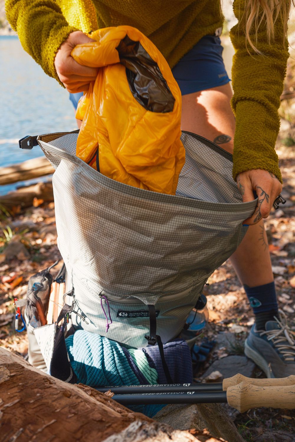 A close-up sequence showing someone putting on climbing chalk from a chalk bag while preparing for rock climbing.