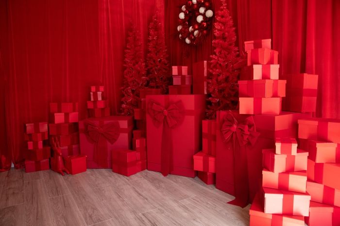 Red-themed Christmas set with illuminated gift boxes and decorated trees creating a magical holiday scene.