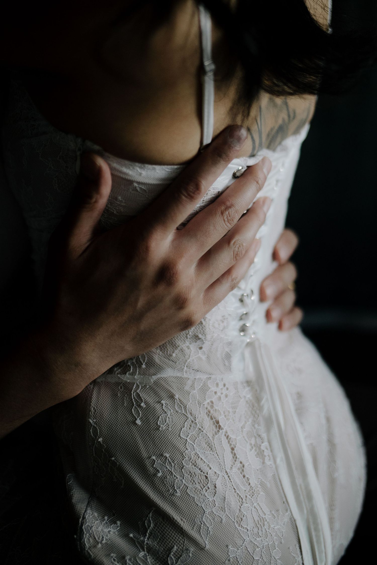 Close-up shots of delicate white lace details on clothing with hands gently touching the fabric.