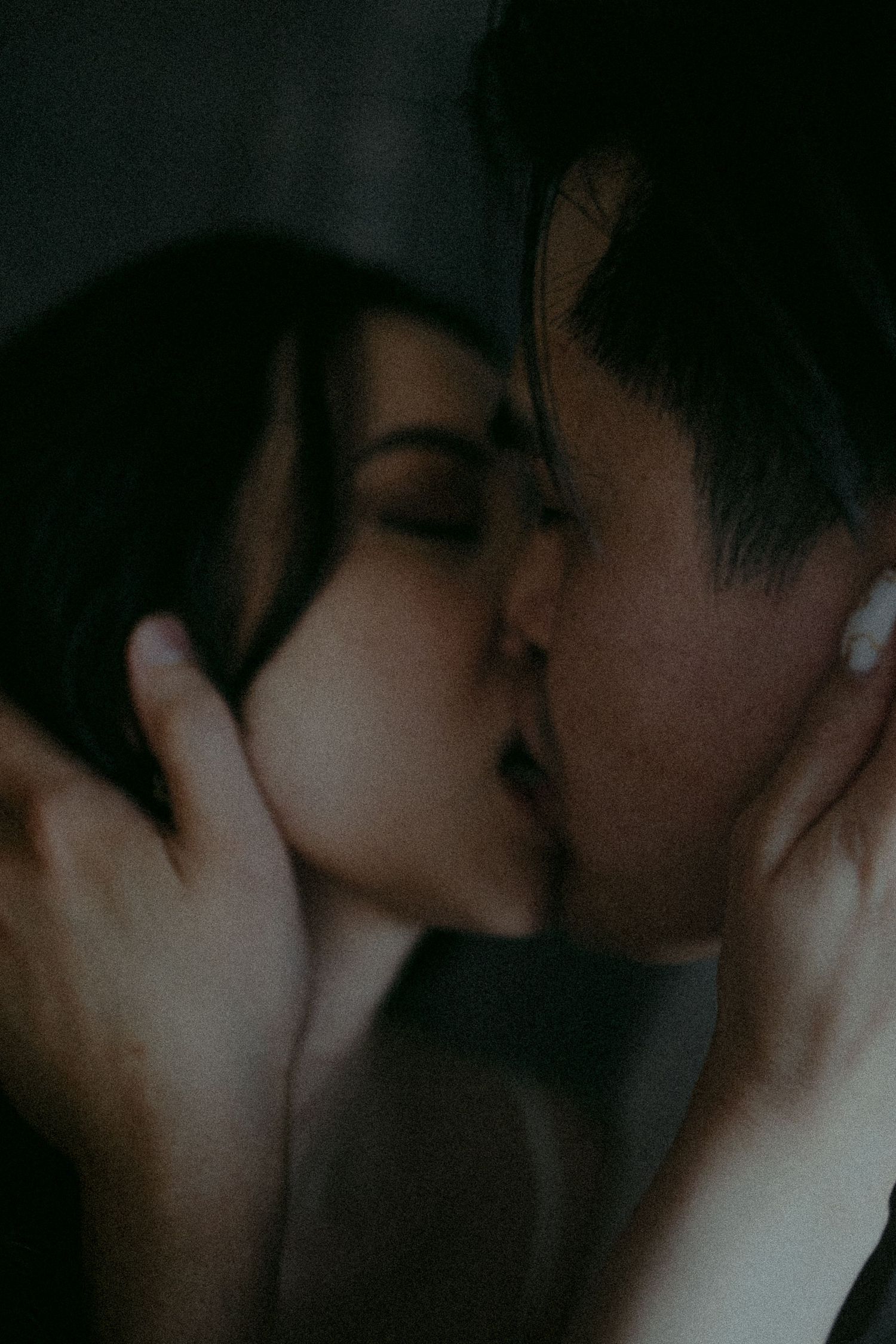 Intimate close-up sequence captured in dark, moody lighting.