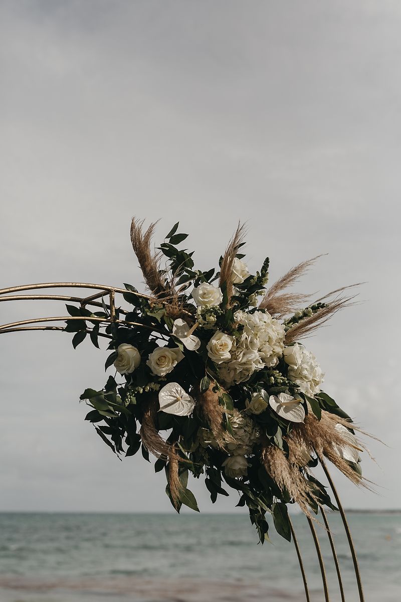 Elegant floral arrangement by the sea at Villa la Joya Playa del Carmen wedding photographer.
