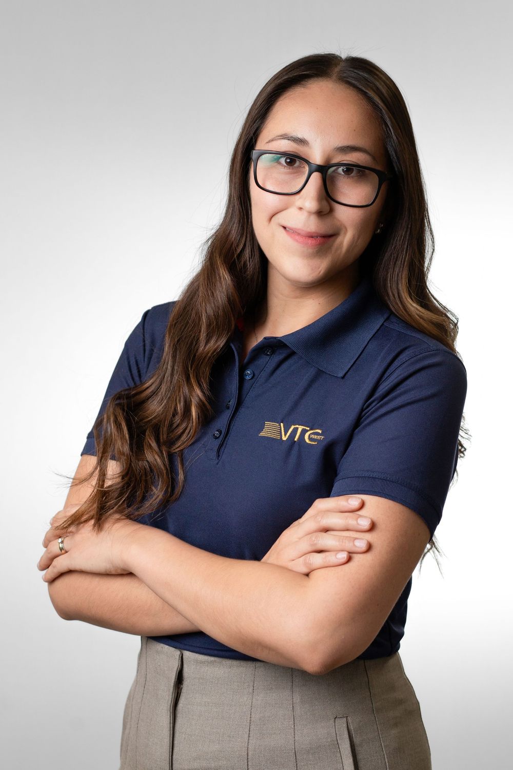 Professional portrait series showing person in navy polo shirt and khaki pants against light background.
