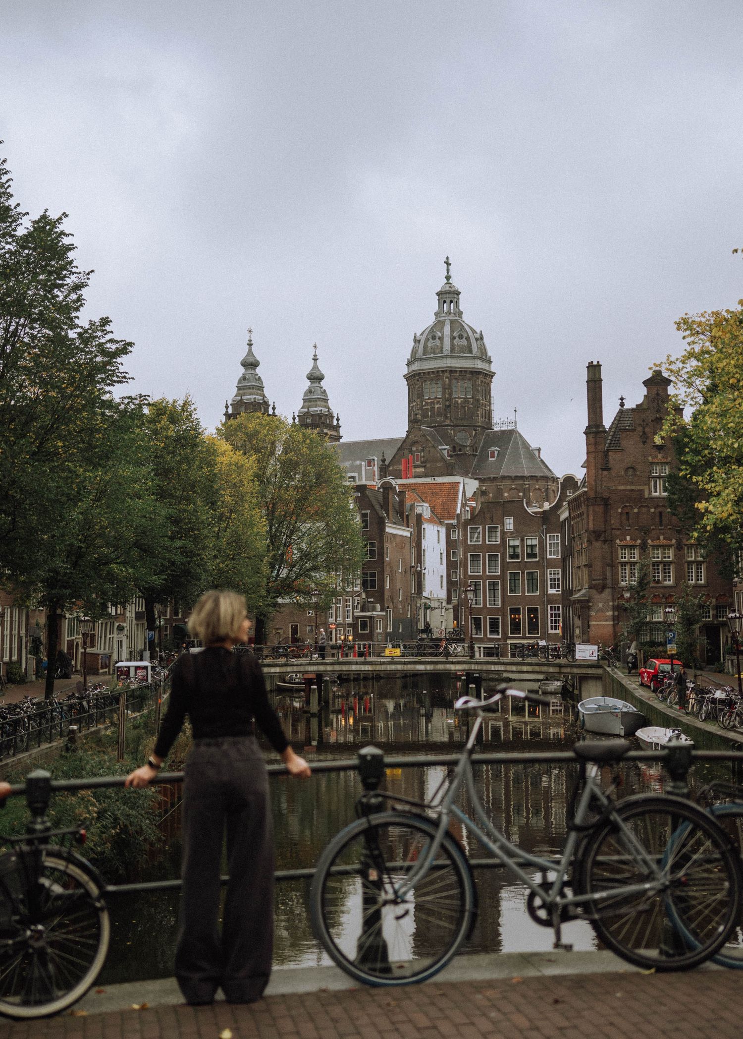 Solo photo of a woman on a bridge near the canal by Oude Kerk.