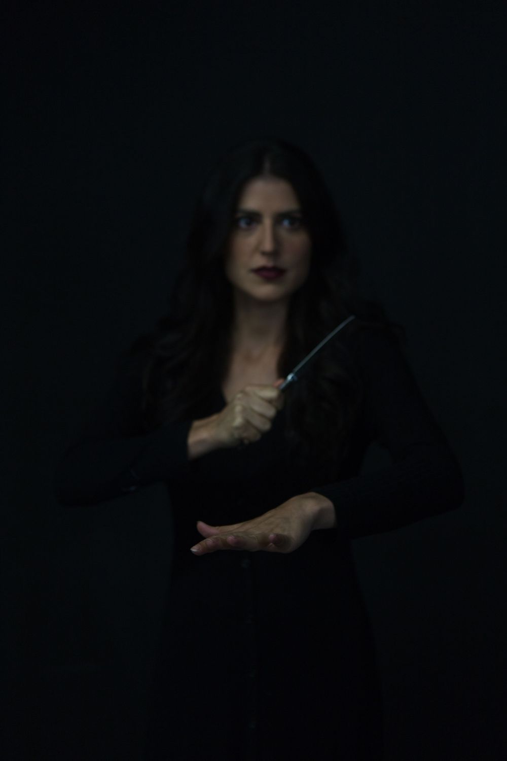 No Name Collective, Macbeth Theatre production promo photography. Dark, low lit moody image of Annaliese Kirby holding dagger.