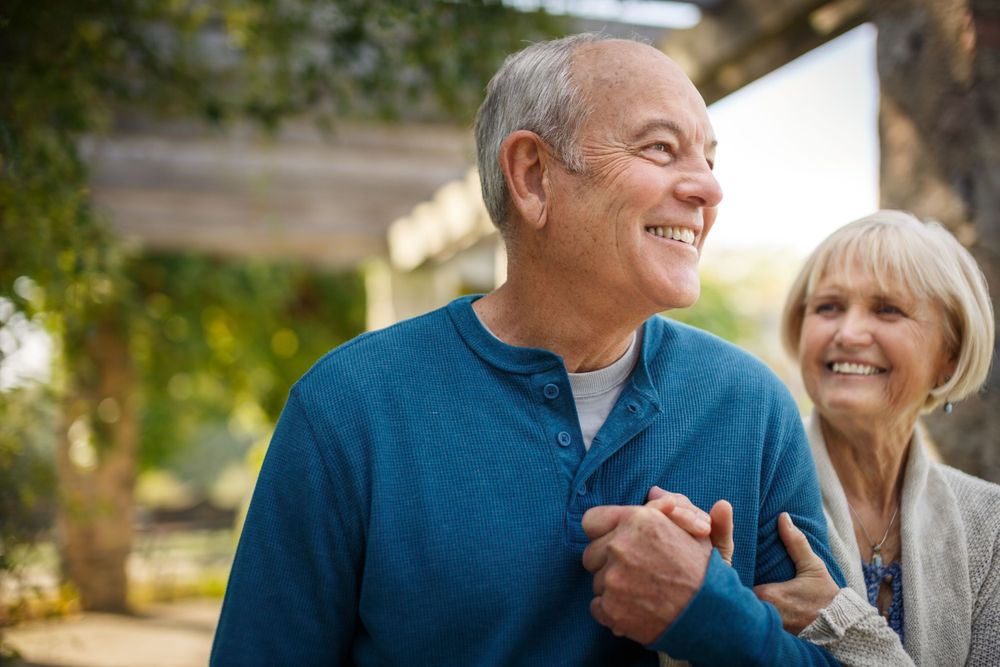 Senior couple sharing a joyful moment outdoors.