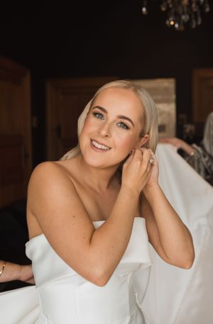 Elegant bridal portrait showing strapless white wedding gown.