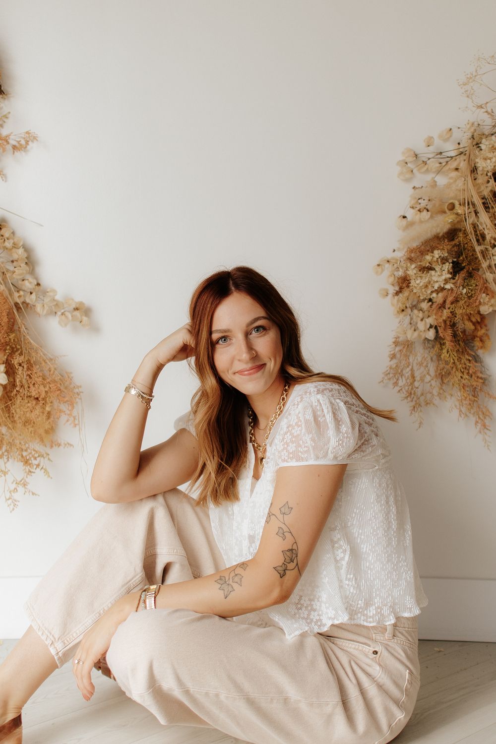 Ethereal portrait series with soft white and cream tones featuring dried pampas grass decor and flowing fabric.