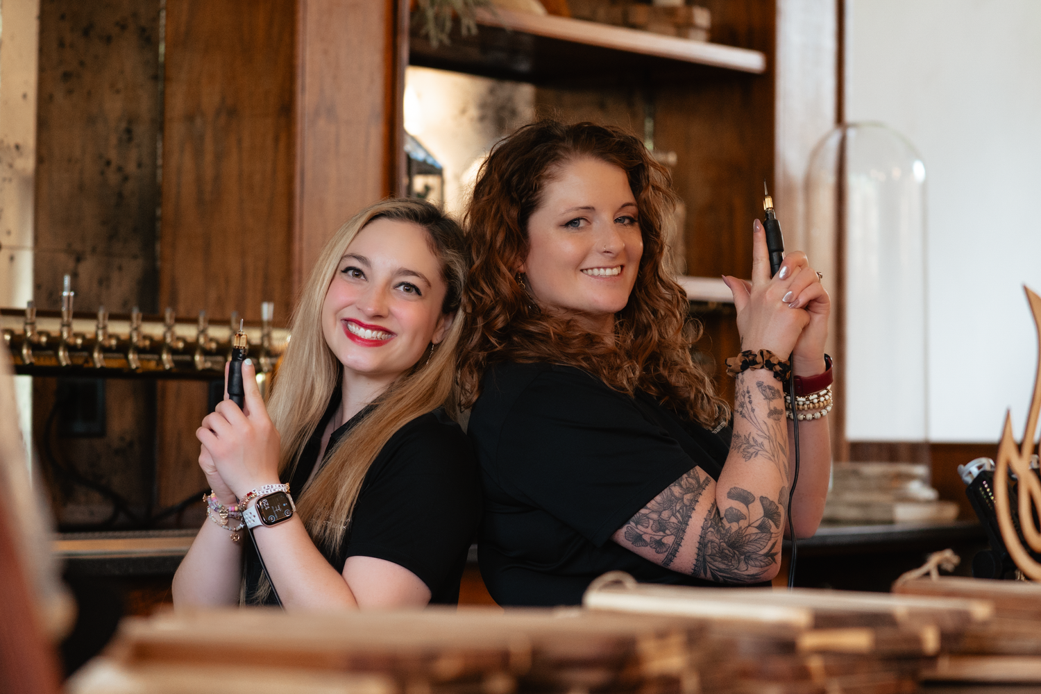 Two smiling people sitting together in a cozy restaurant interior with warm lighting and wooden decor.