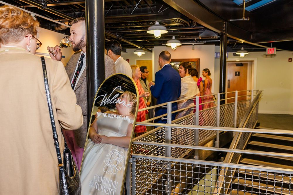 People browsing items displayed on wire shelving units in a retail space.