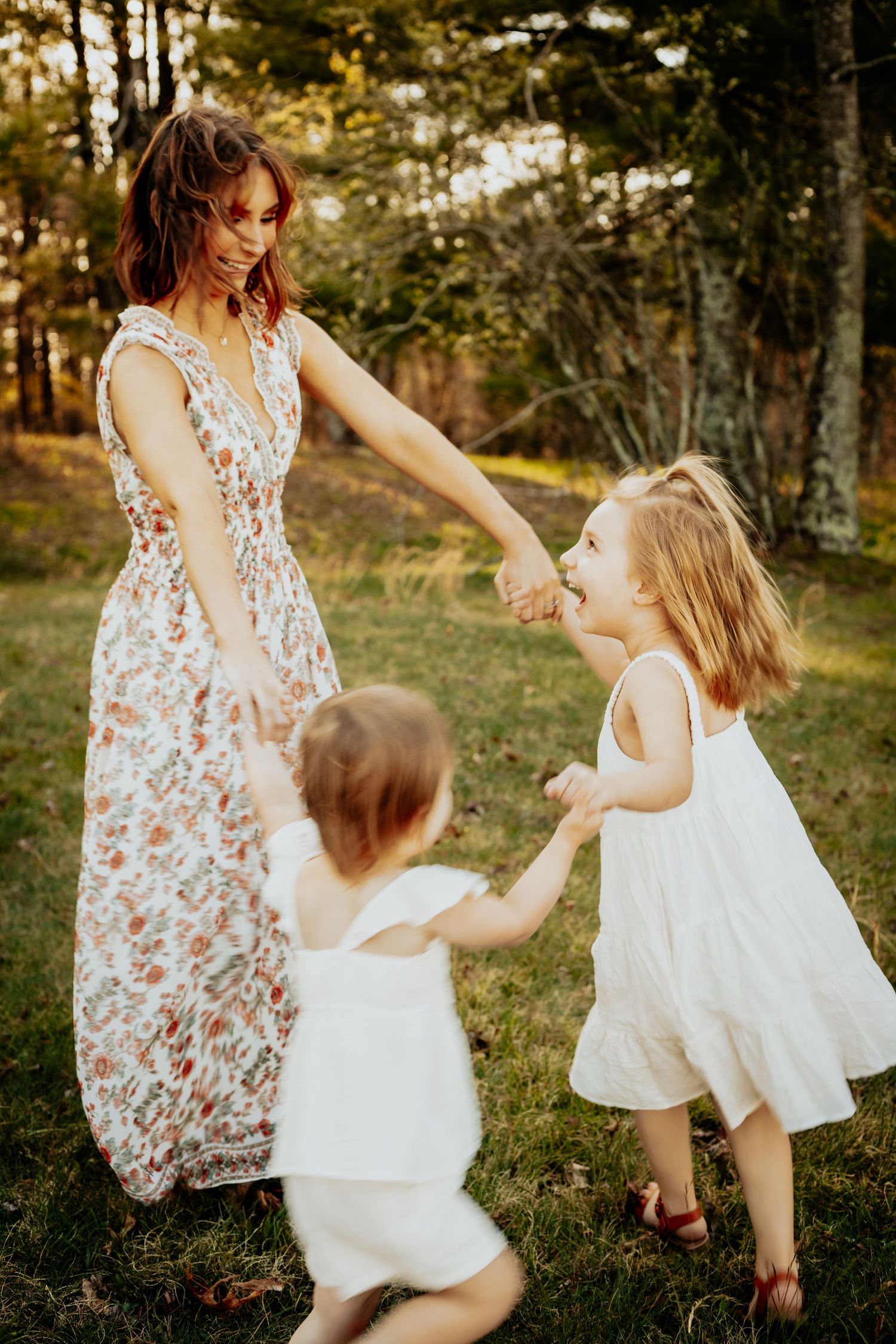 Jac and her daughters dancing in the grass on the Blue Ridge Parkway.